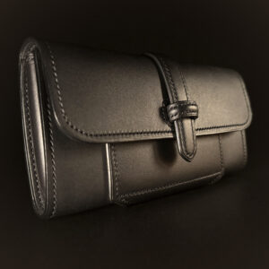 Luxury handstitched matte black clutch purse with unique tab closure view of front of closed purse