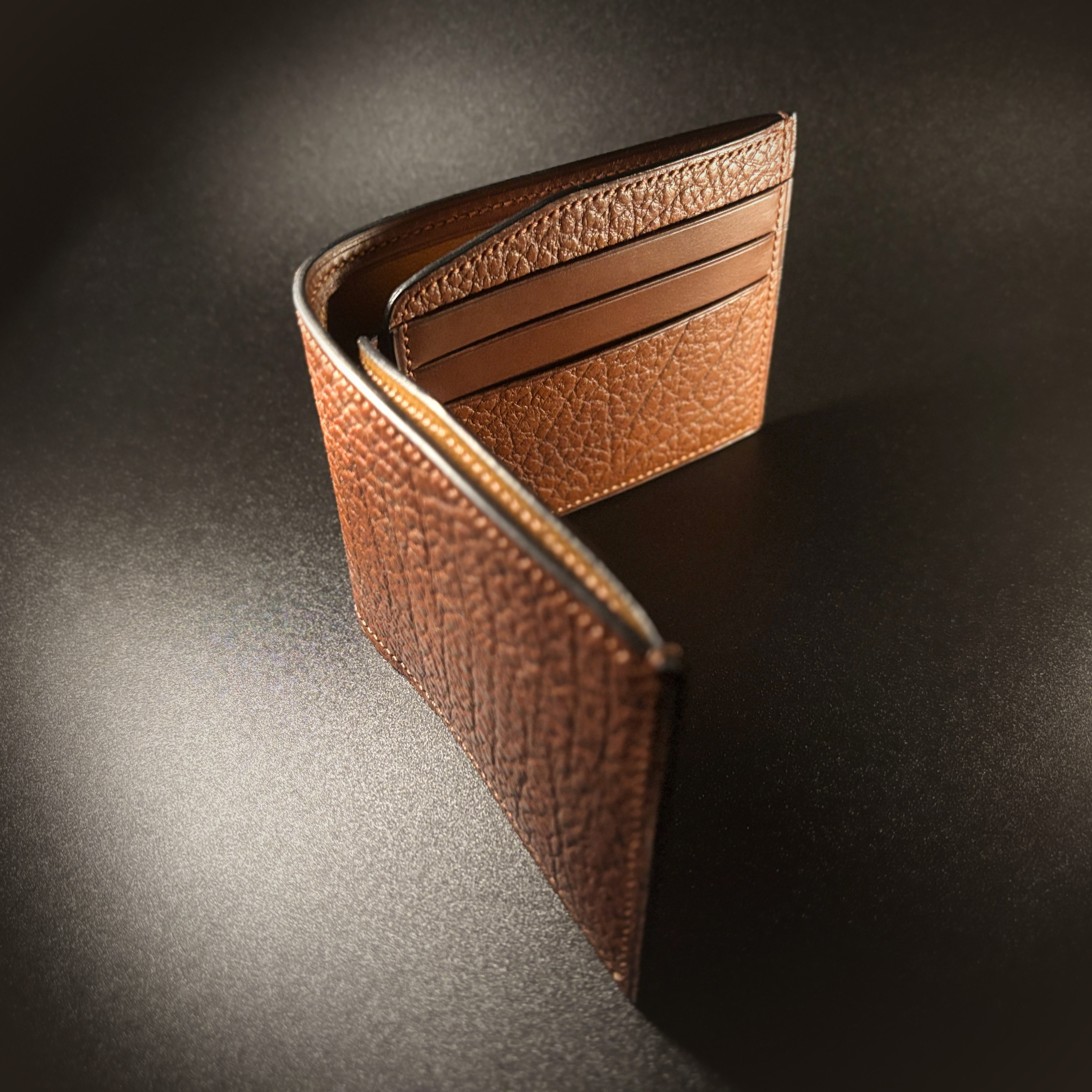 Unique handstitched textured terrracotta brown bifold wallet side view