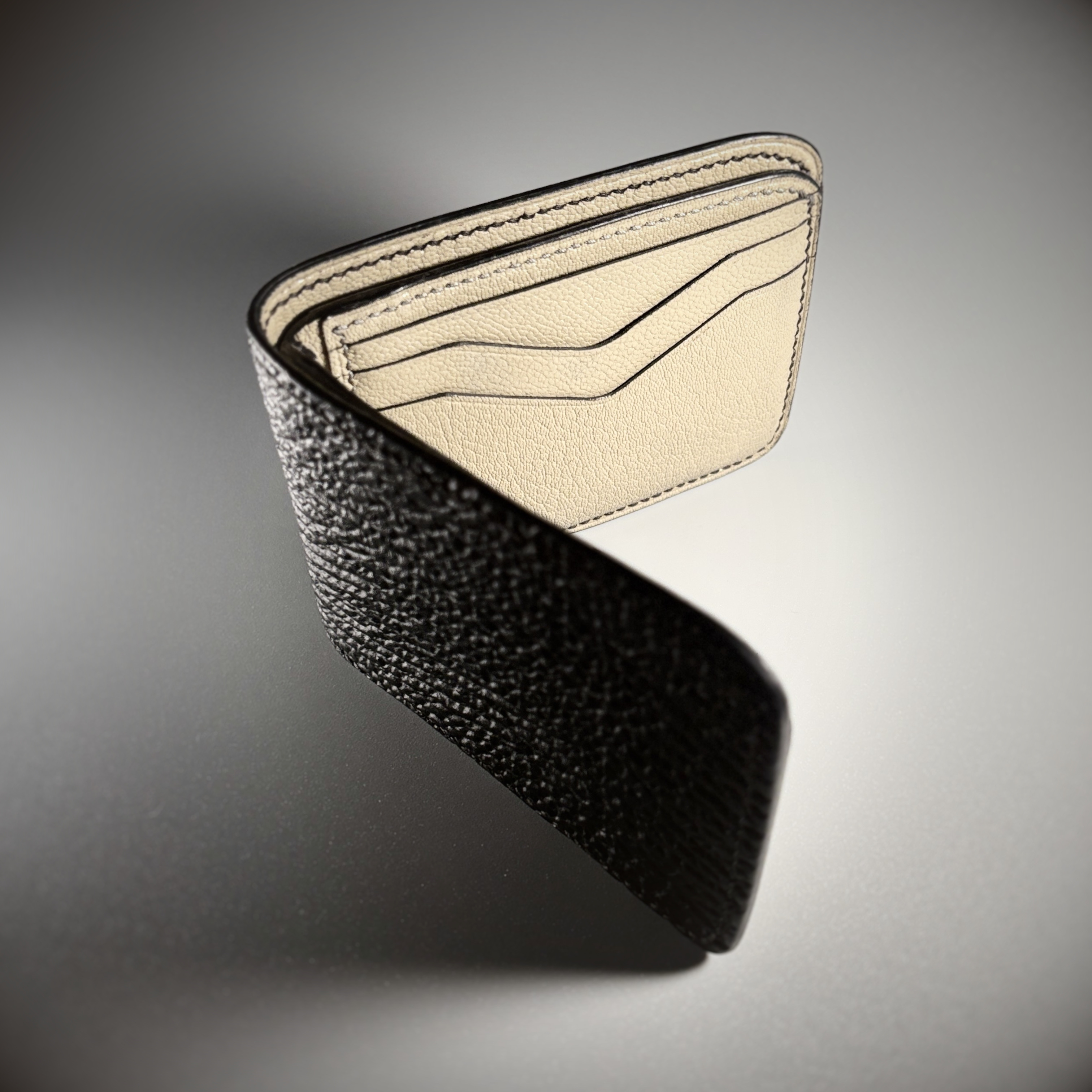 Unique handstitched black shark leather shell and light tan chevron patterned interior bifold wallet side view