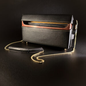 Luxury handstitched black ochre and reddish brown box purse with unique hinged opening and brass hardware and brass chain strap view of front of open purse with brass chain strap
