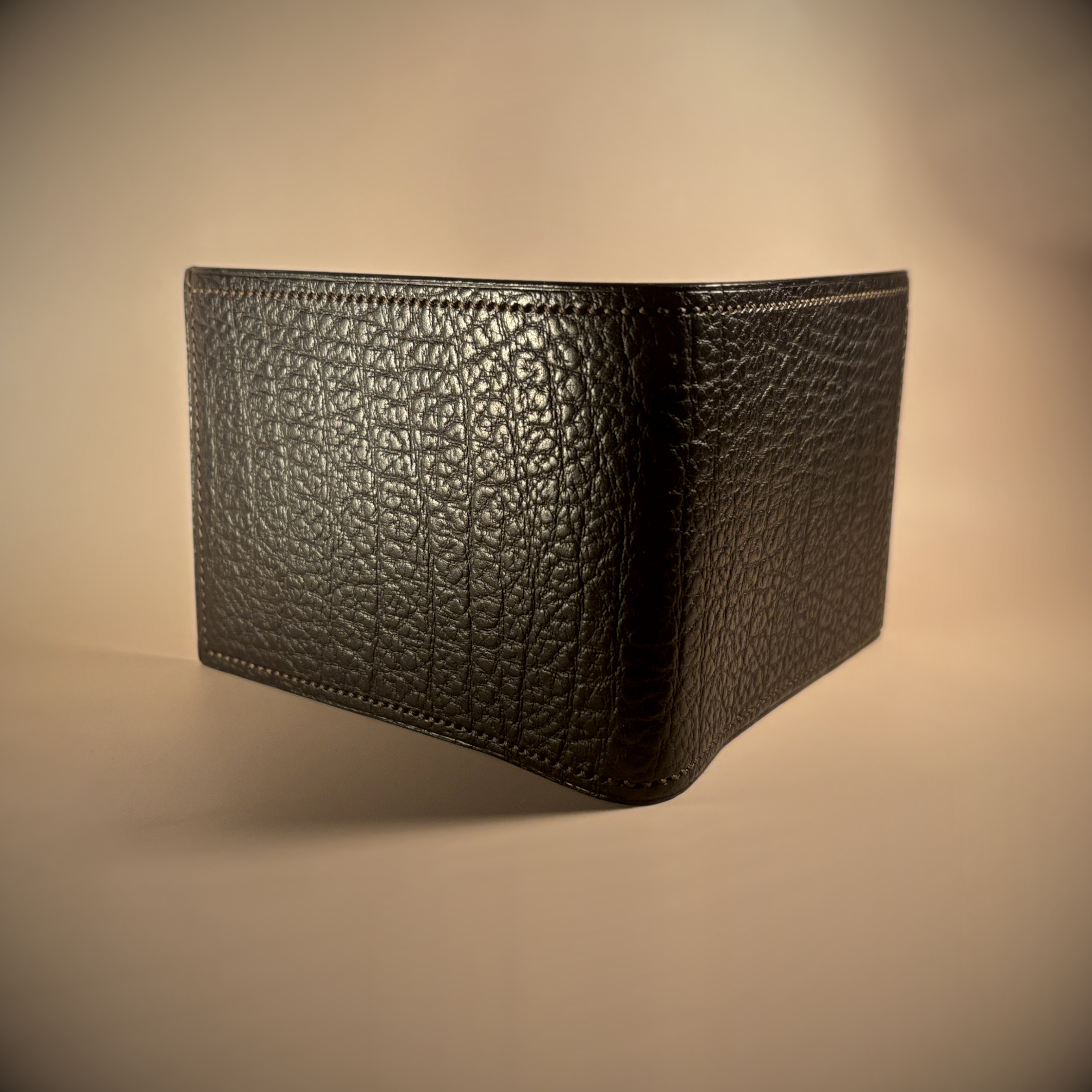 Unique handstitched textured dark brown shell and textured and smooth brown and taupe interior bifold wallet exterior shell view