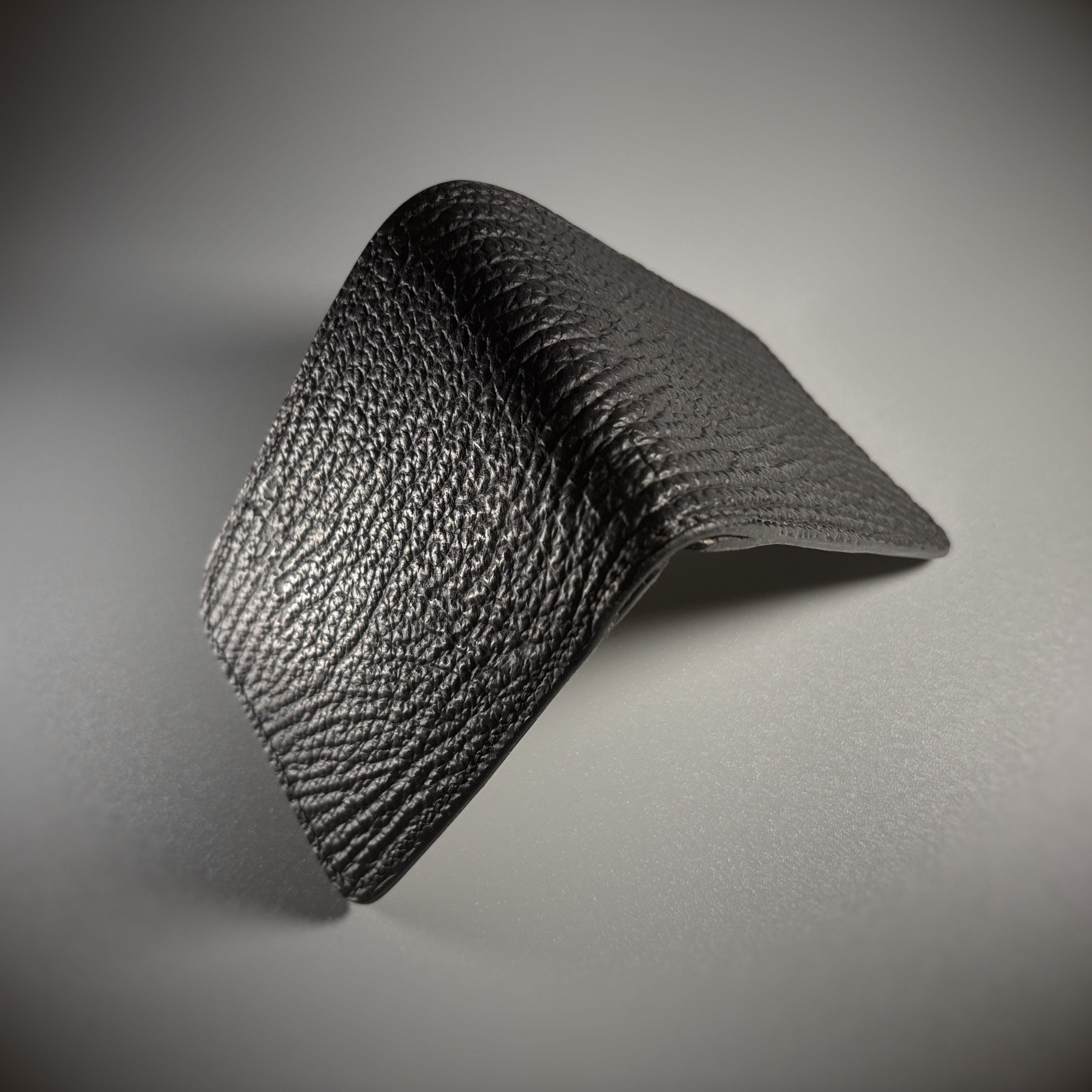 Unique handstitched black shark leather shell and light tan chevron patterned interior bifold wallet exterior shell view