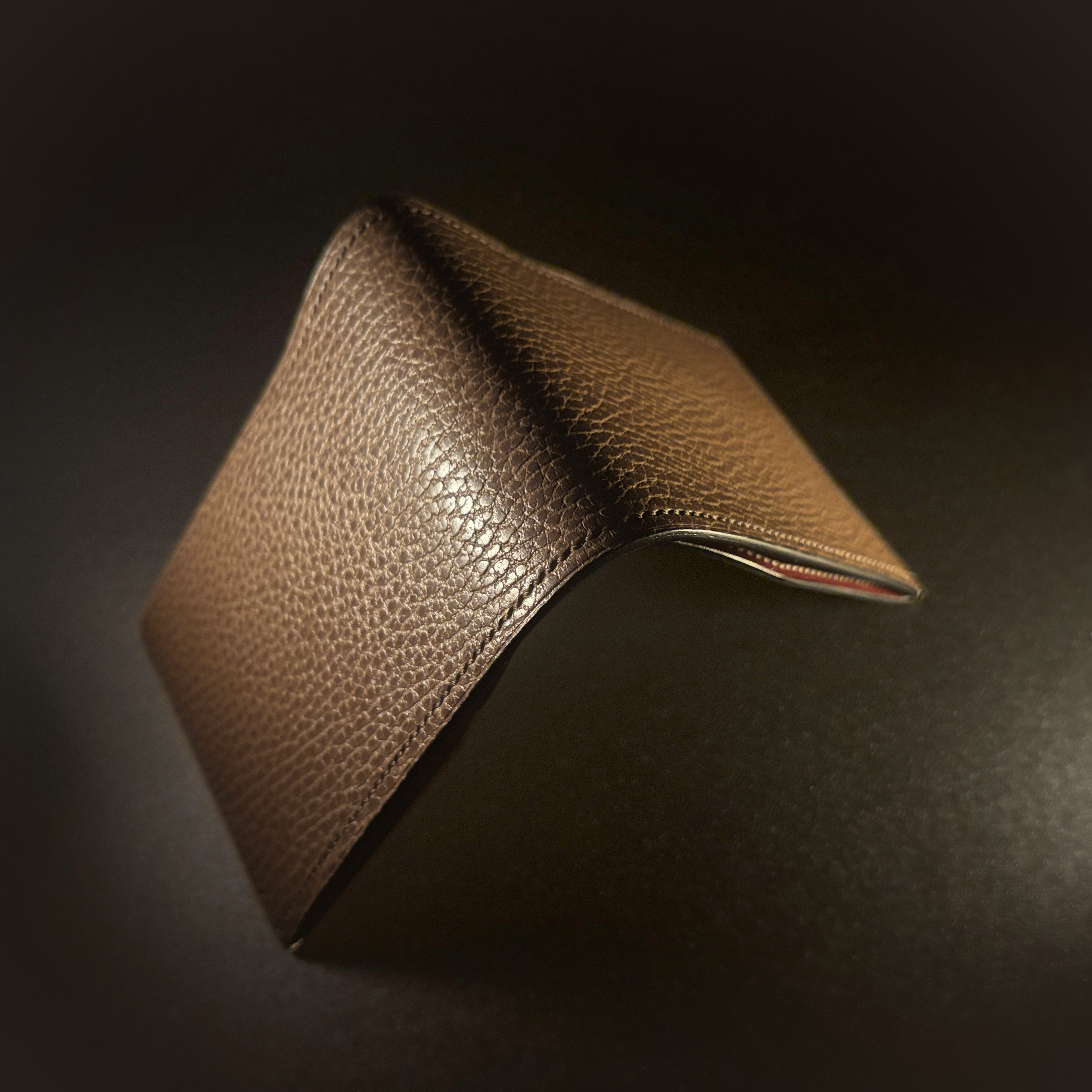 Unique handstitched textured taupe with red accent cash compartment bifold wallet exterior shell view