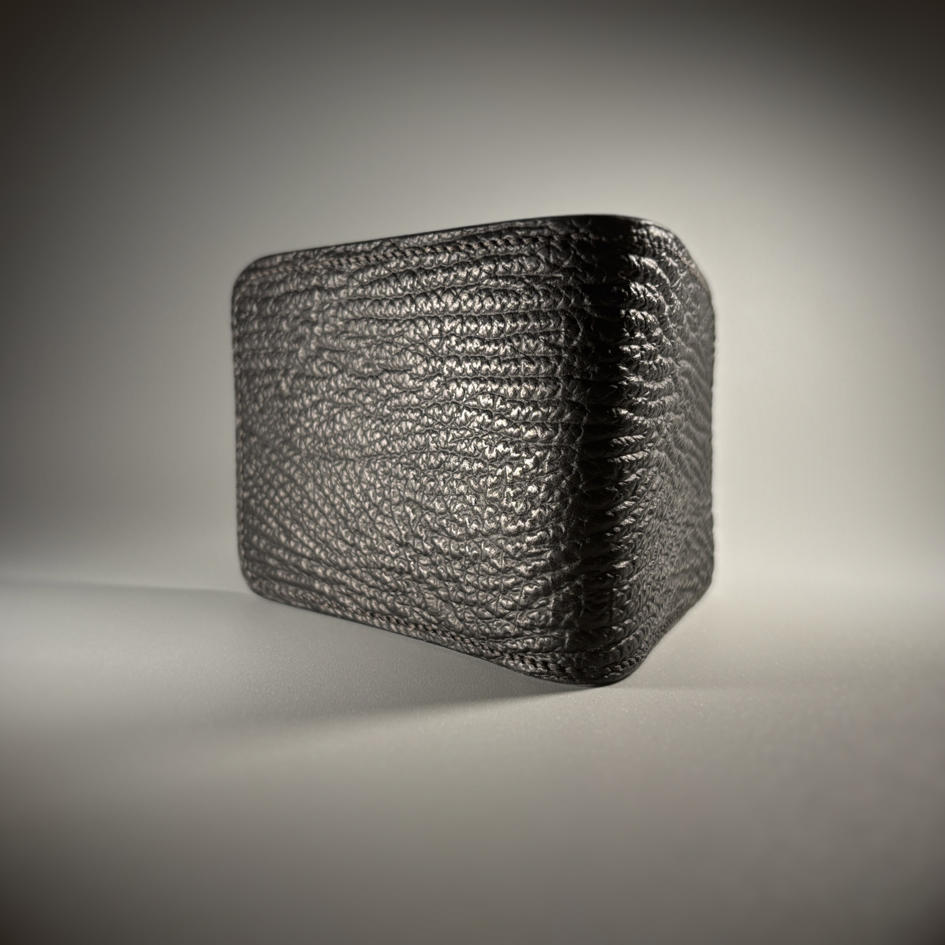 Unique handstitched black shark leather shell and light tan chevron patterned interior bifold wallet exterior shell view