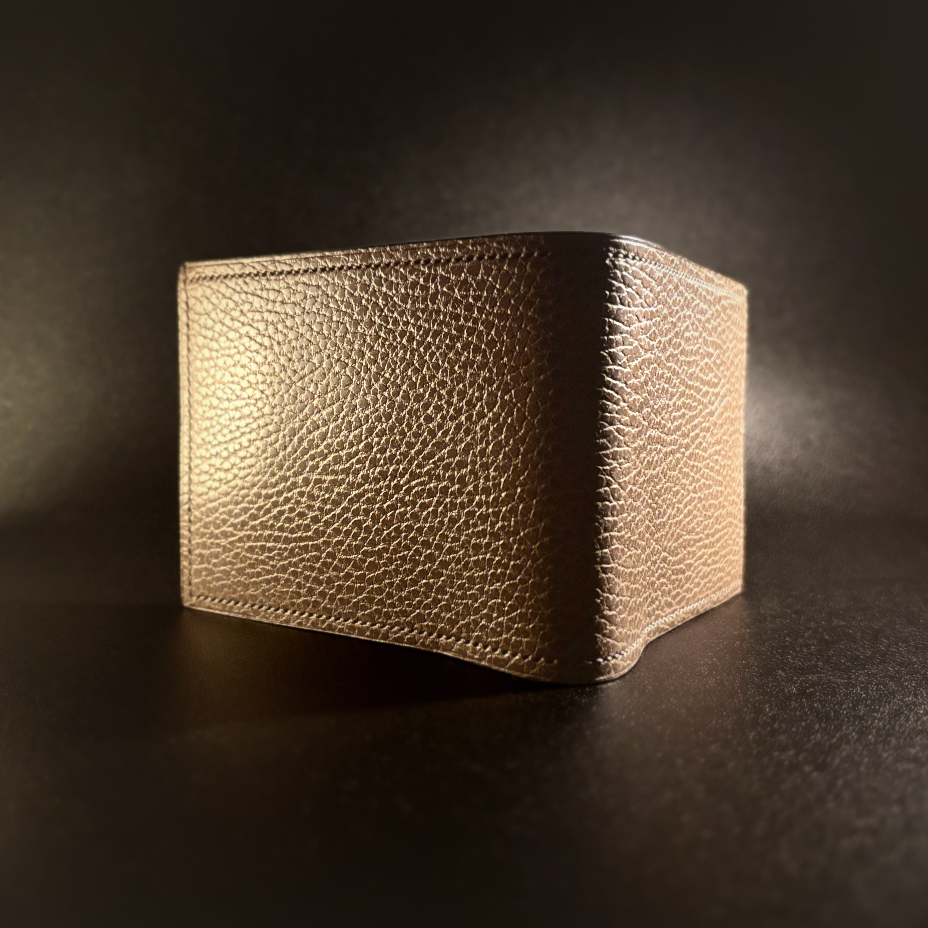 Unique handstitched textured taupe with red accent cash compartment bifold wallet exterior shell view