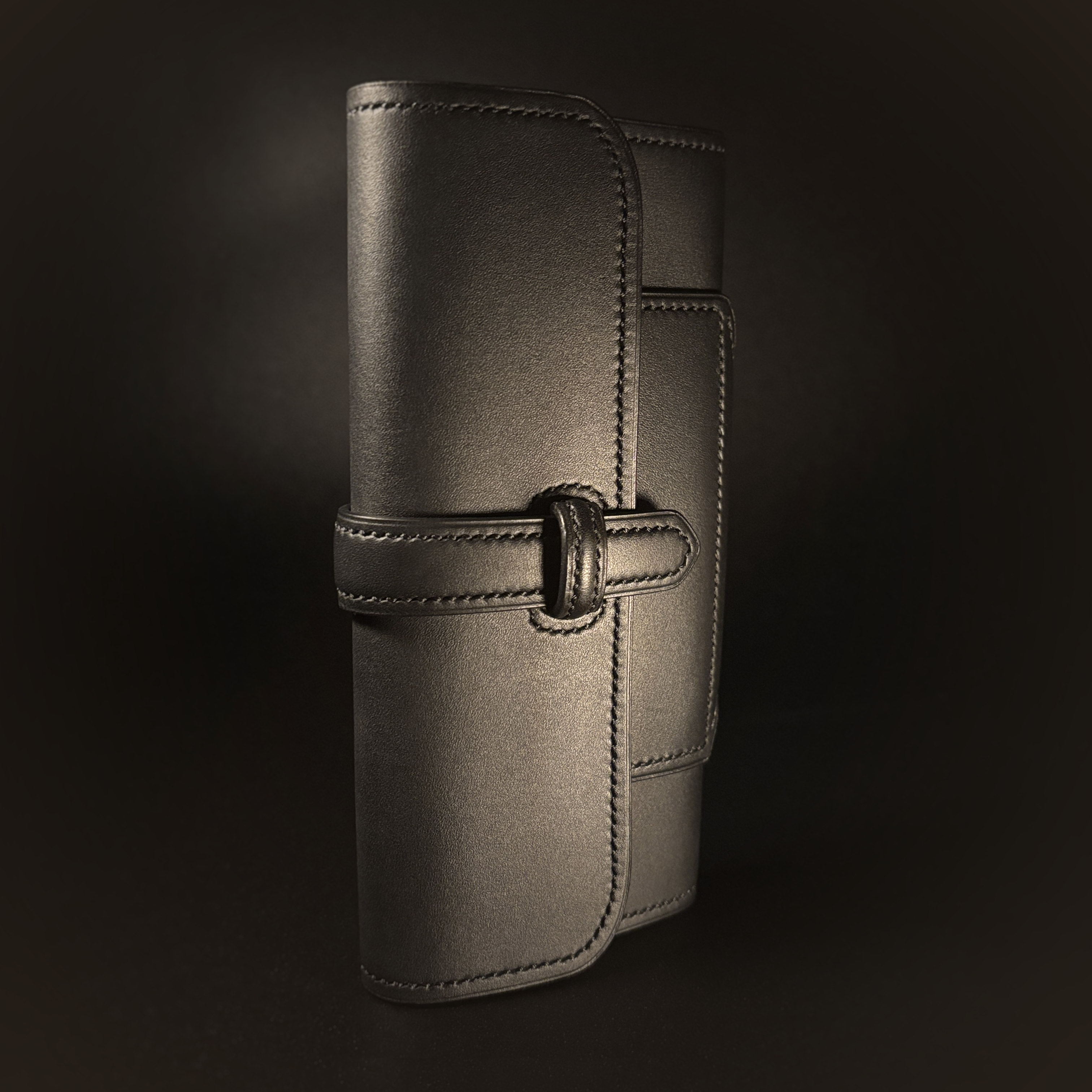 Luxury handstitched matte black clutch purse with unique tab closure view of front and top of closed purse