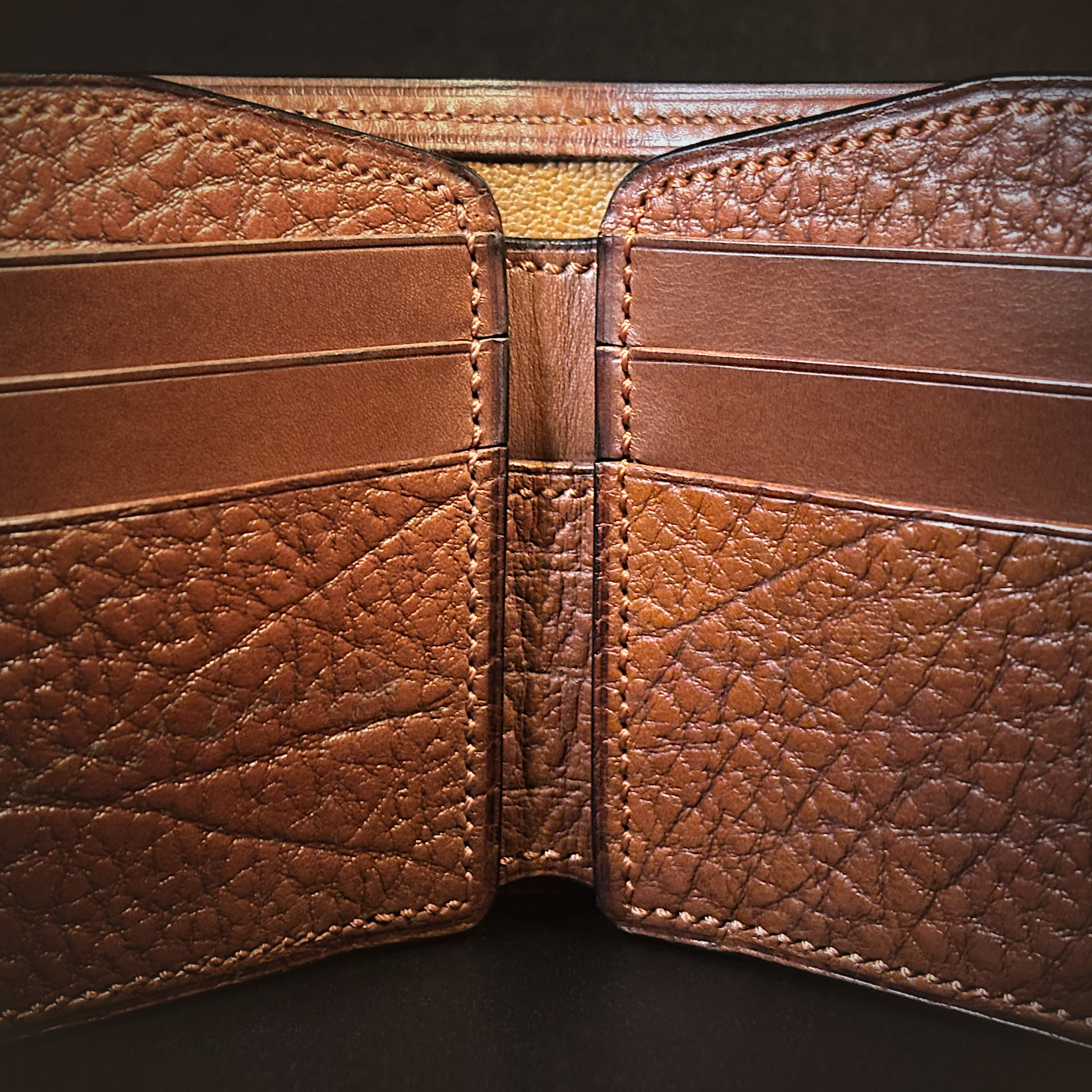 Unique handstitched textured terrracotta brown bifold wallet interior detail view