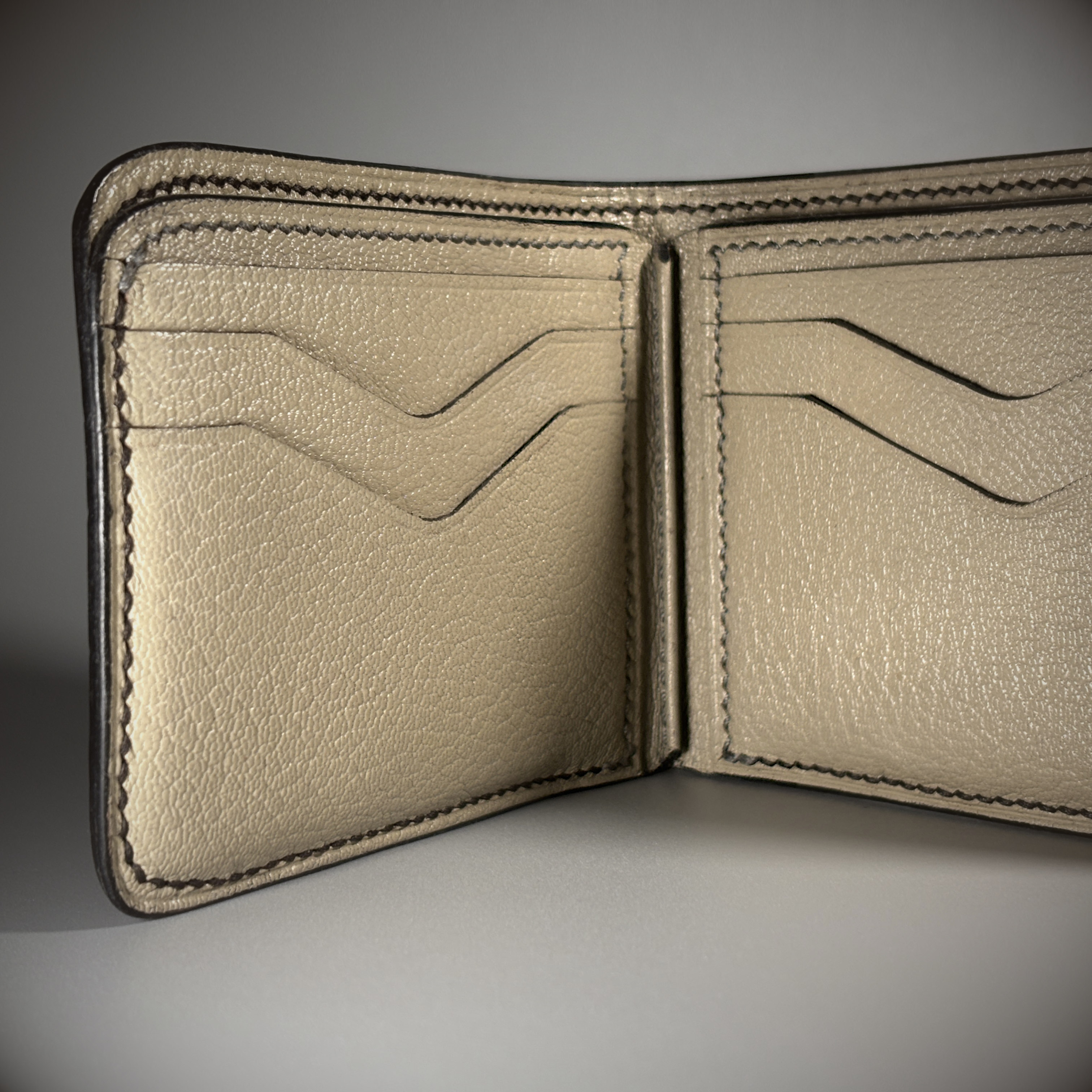 Unique handstitched black shark leather shell and light tan chevron patterned interior bifold wallet interior detail view