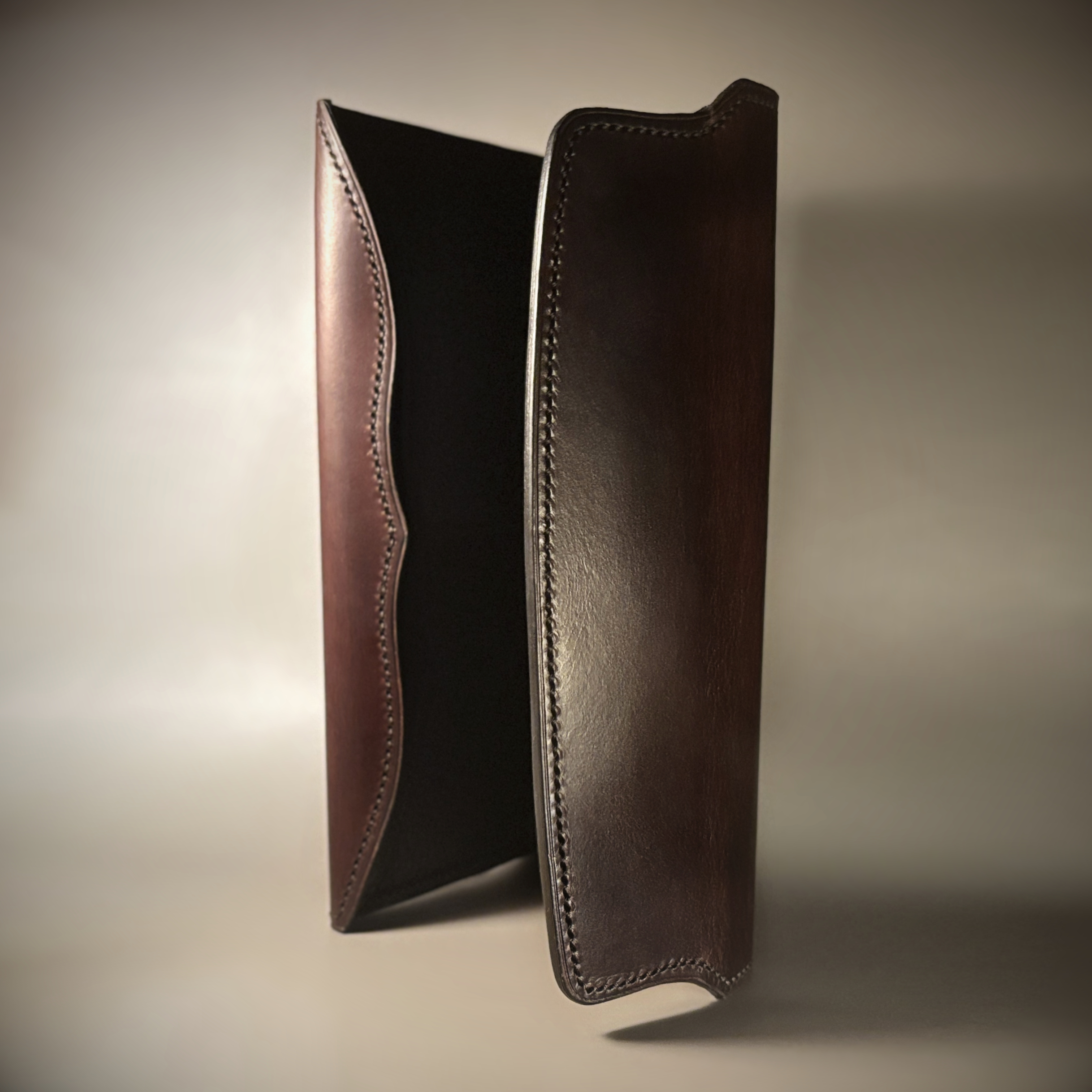 Unique handstitched tuck closure walnut shell and black and brown textured curved interior long wallet interior vertical view