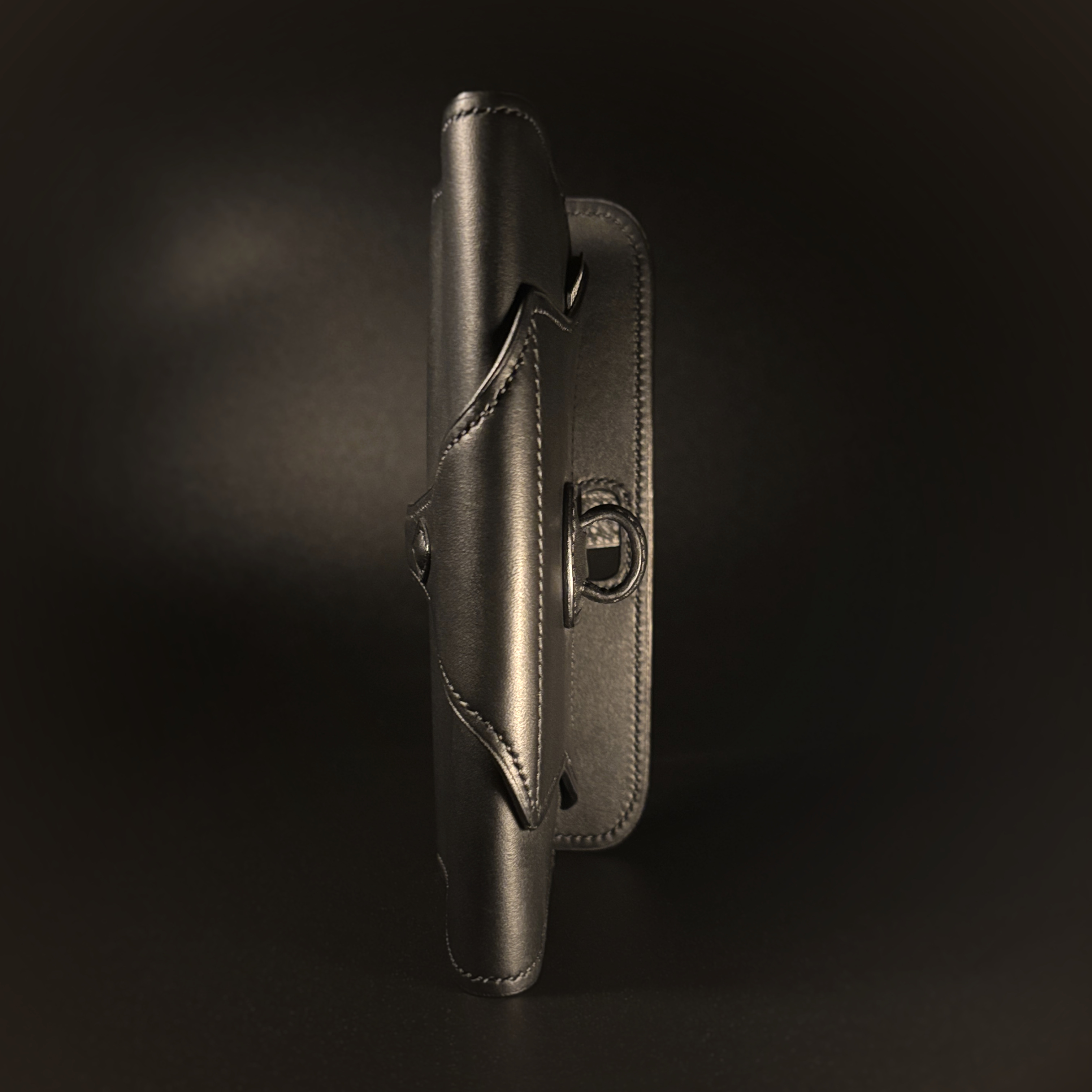 Luxury handstitched matte black clutch purse with unique tab closure view of side of opened purse