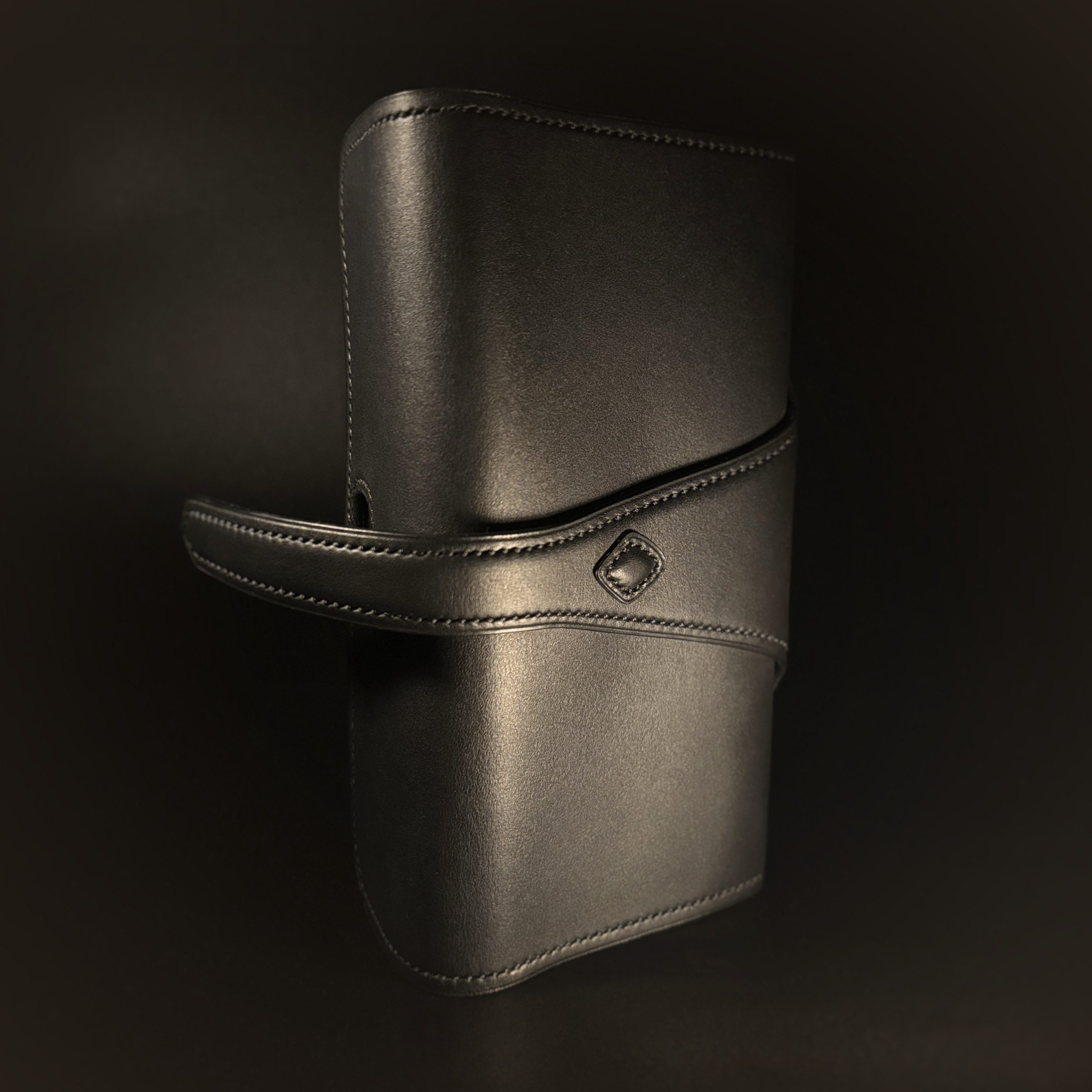 Luxury handstitched matte black clutch purse with unique tab closure view of back of opened purse