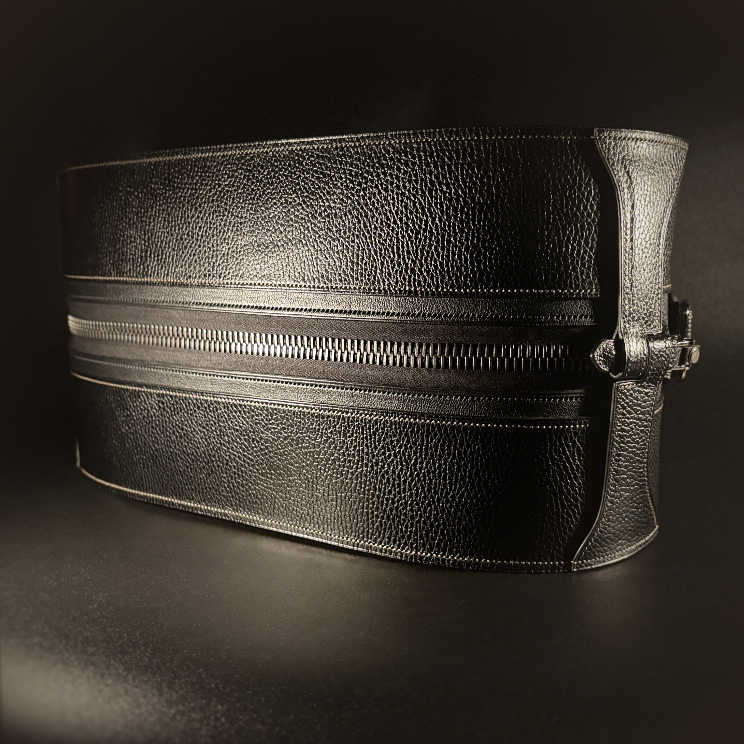 Luxury handstitched black and taupe leather messenger carryall bag with flowing curved design of handles and strap view of top and zipper with crossbody strap detached