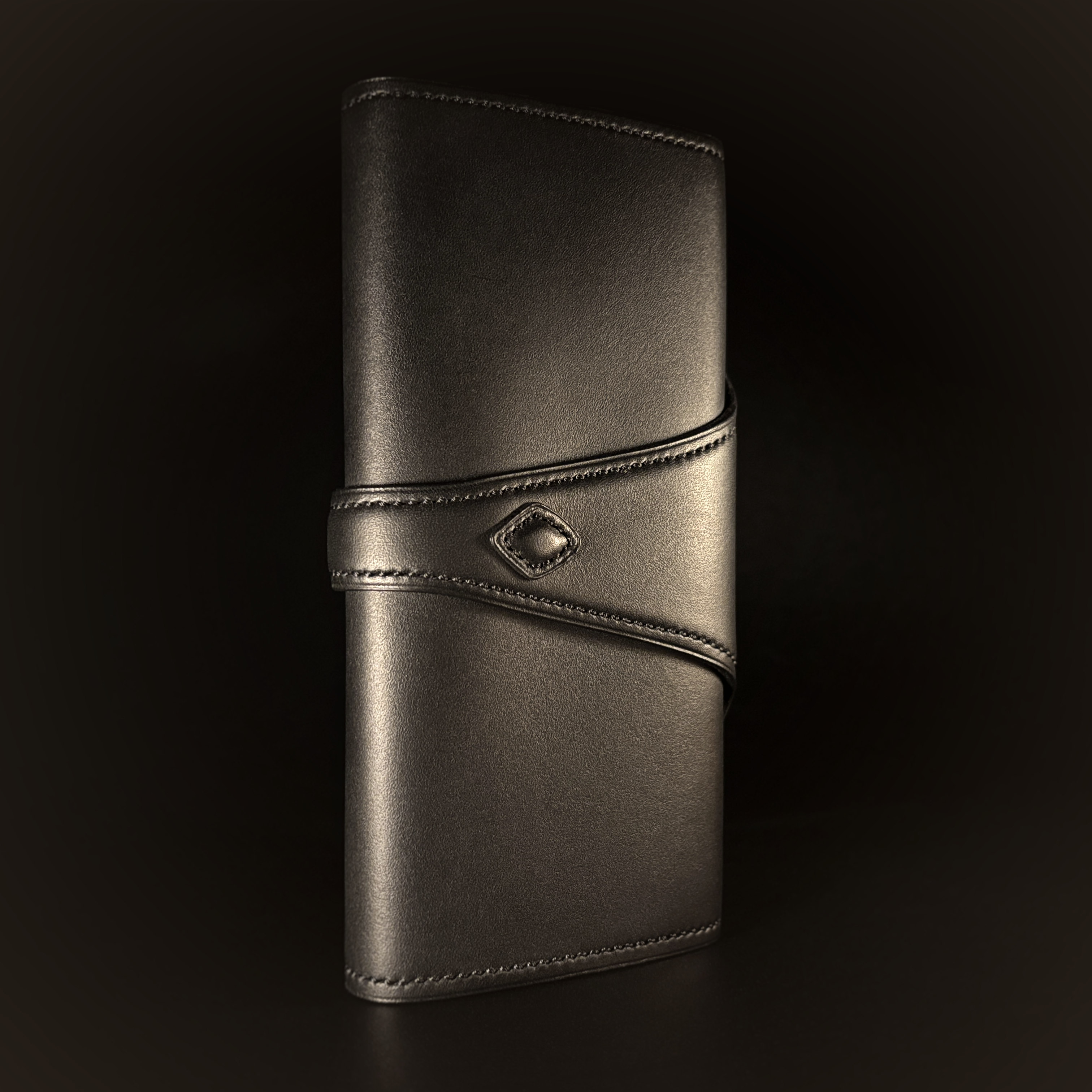 Luxury handstitched matte black clutch purse with unique tab closure view of back of closed purse