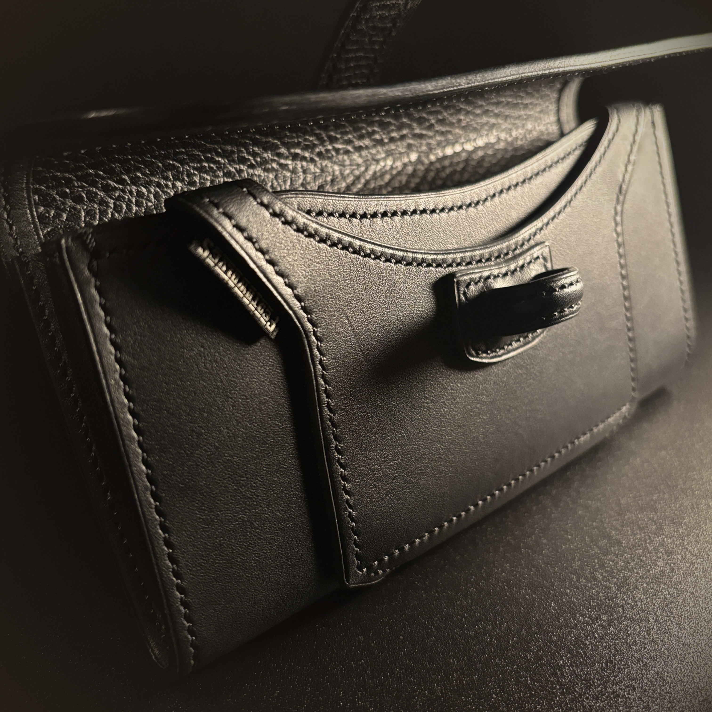 Luxury handstitched matte black clutch purse with unique tab closure view of front of opened purse