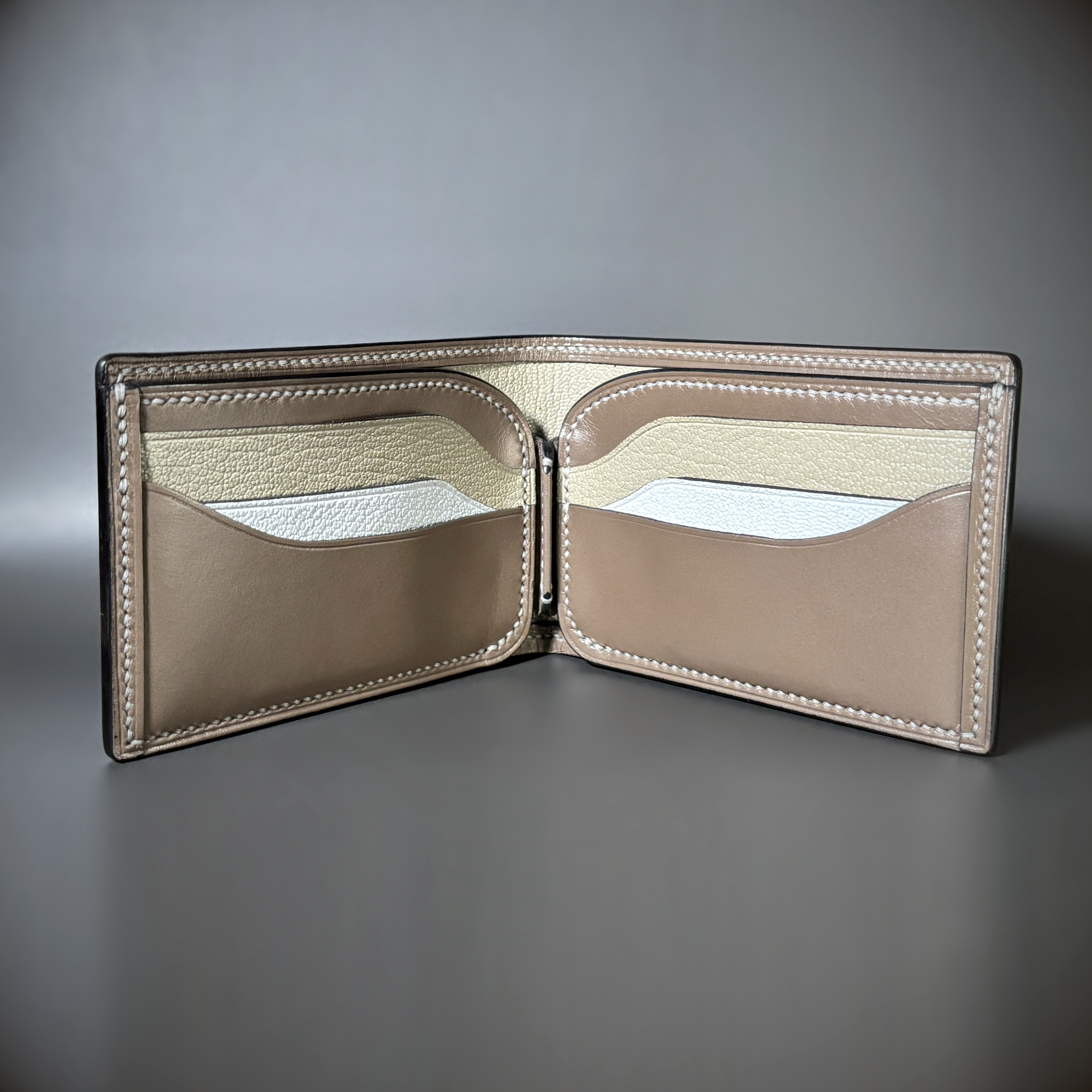 Tan taupe and white bifold wallet with black shell handstitched with white thread interior view