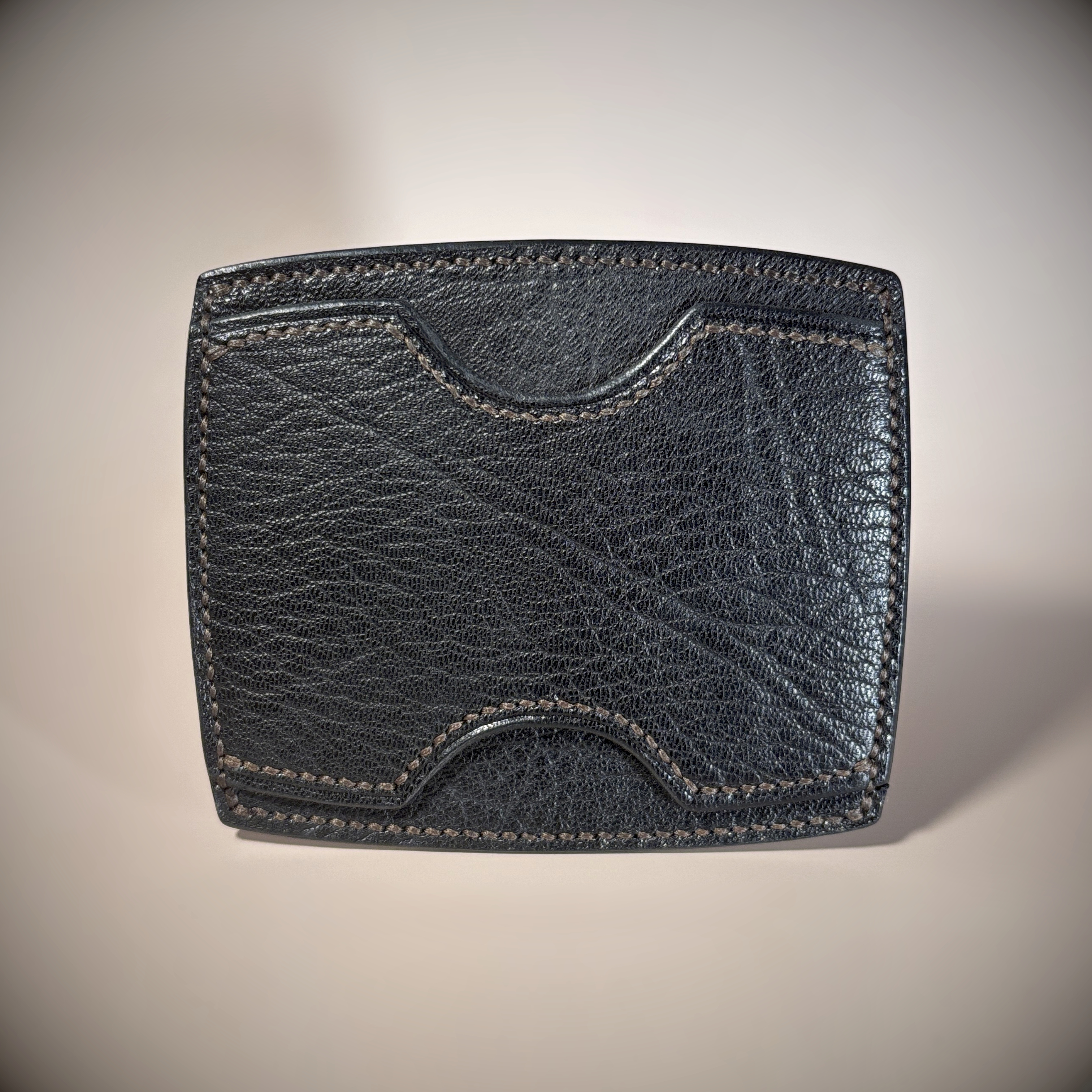 Black slim-line unique card wallet hand-stitched with brown thread