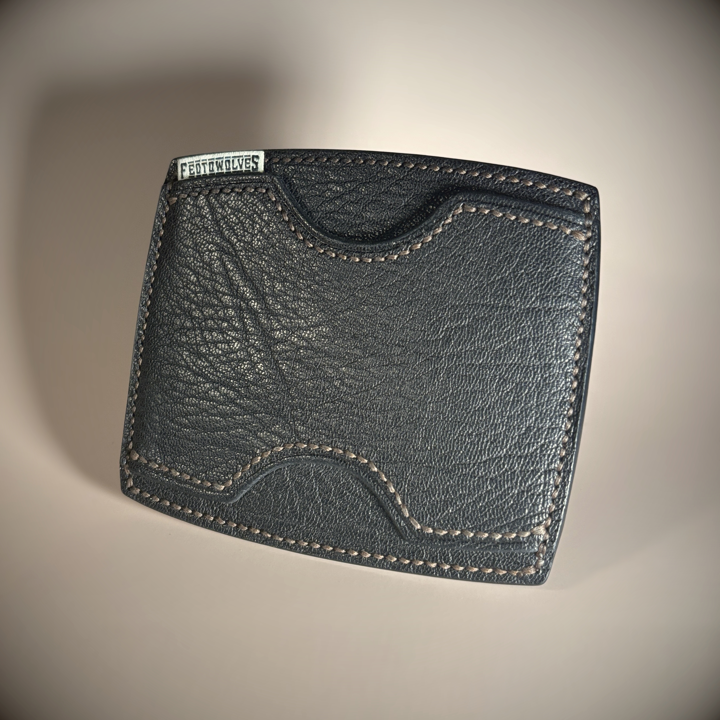 Black slim-line unique card wallet hand-stitched with brown thread