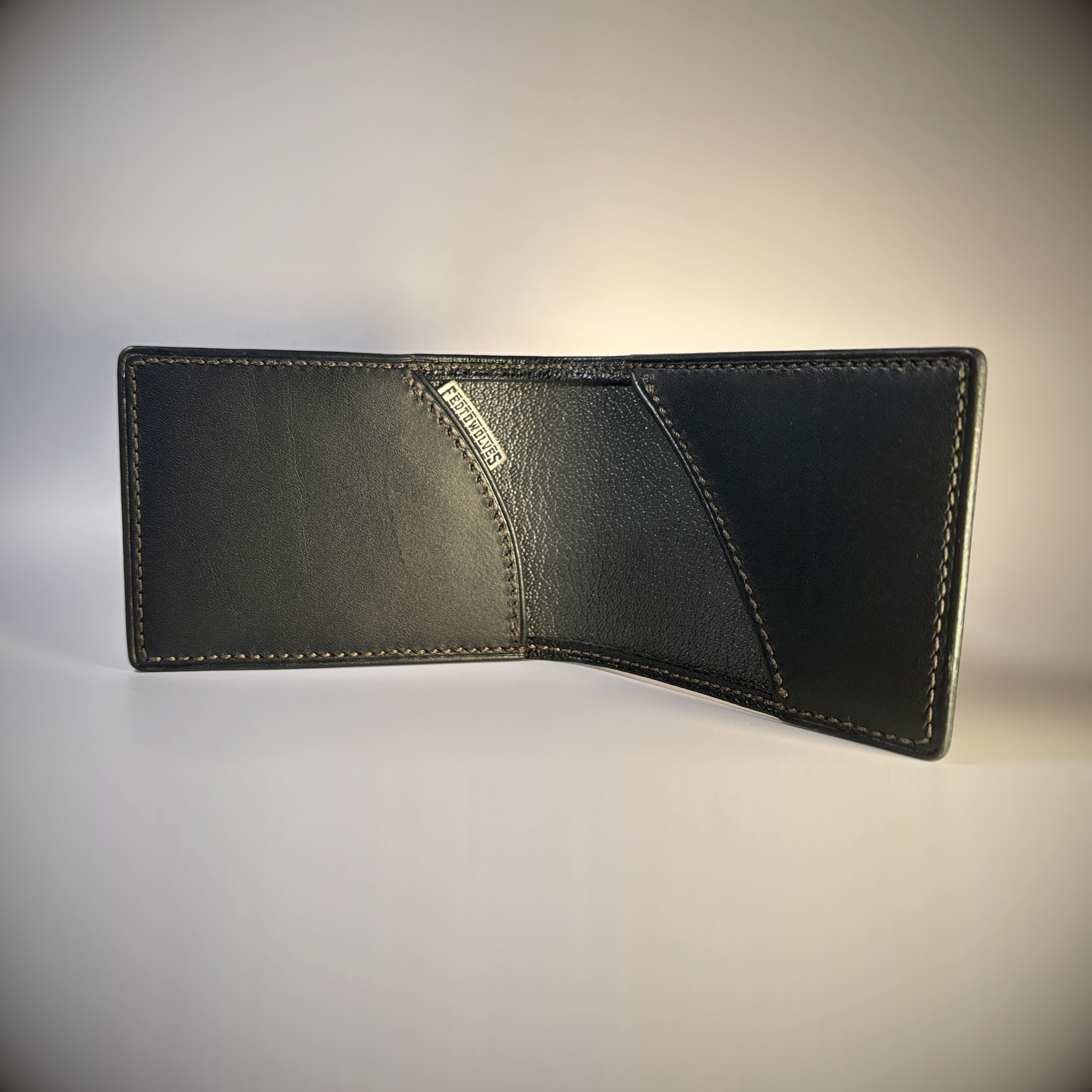 Black slim line folding card wallet hand-stitched taupe stitching inteior view