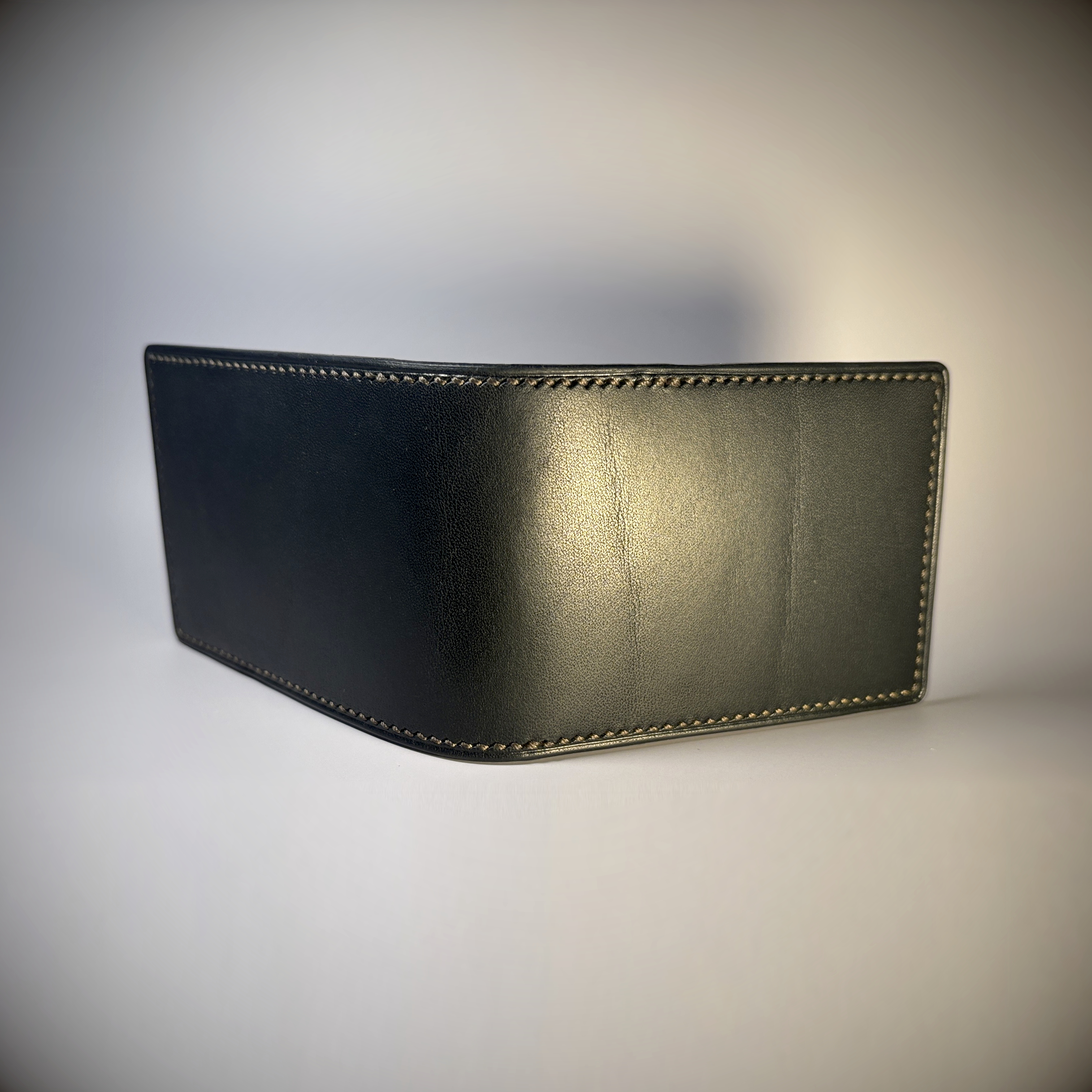 Black slim line folding card wallet hand-stitched taupe stitching exterior shell view