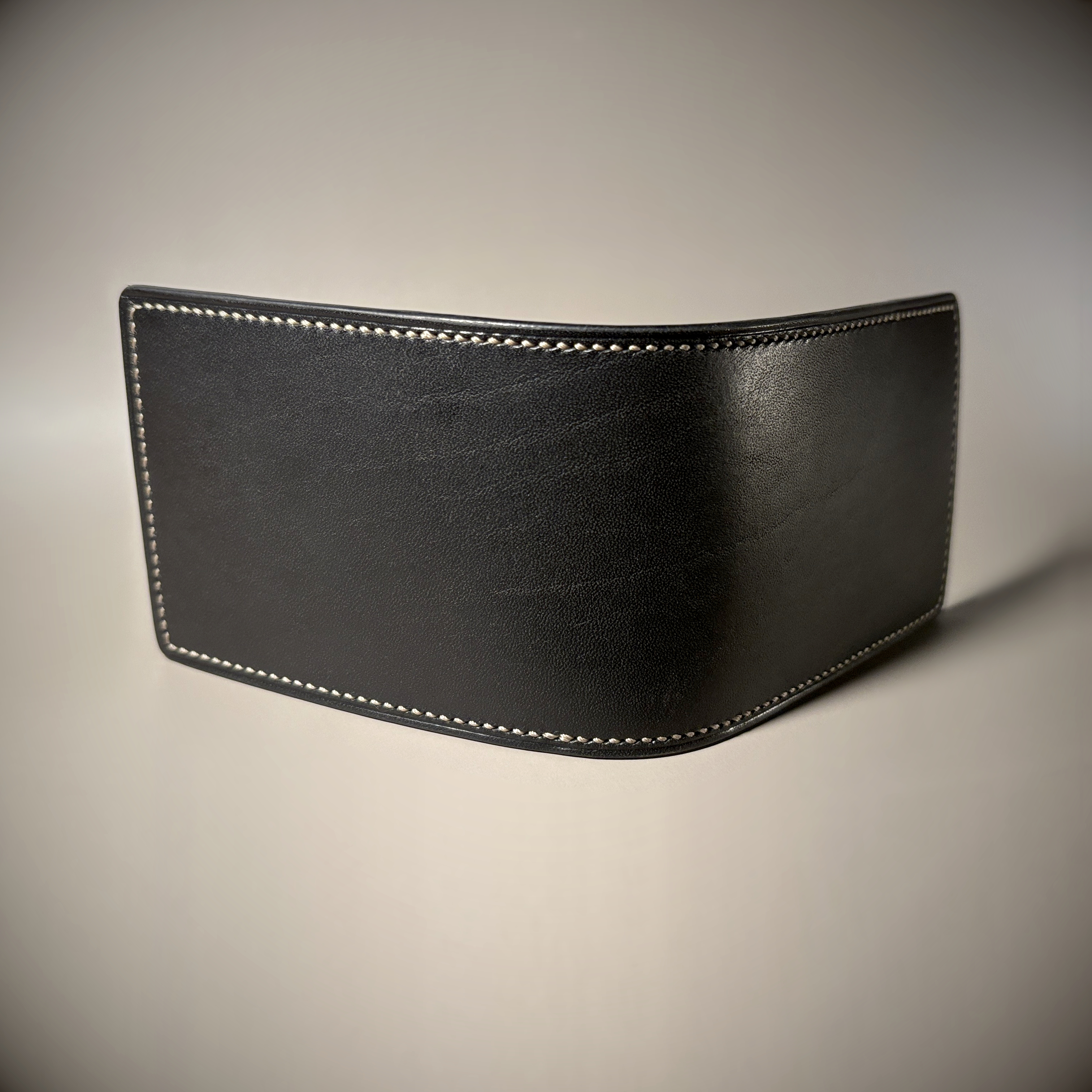 Black slim line folding card wallet hand-stitched exterior shell view