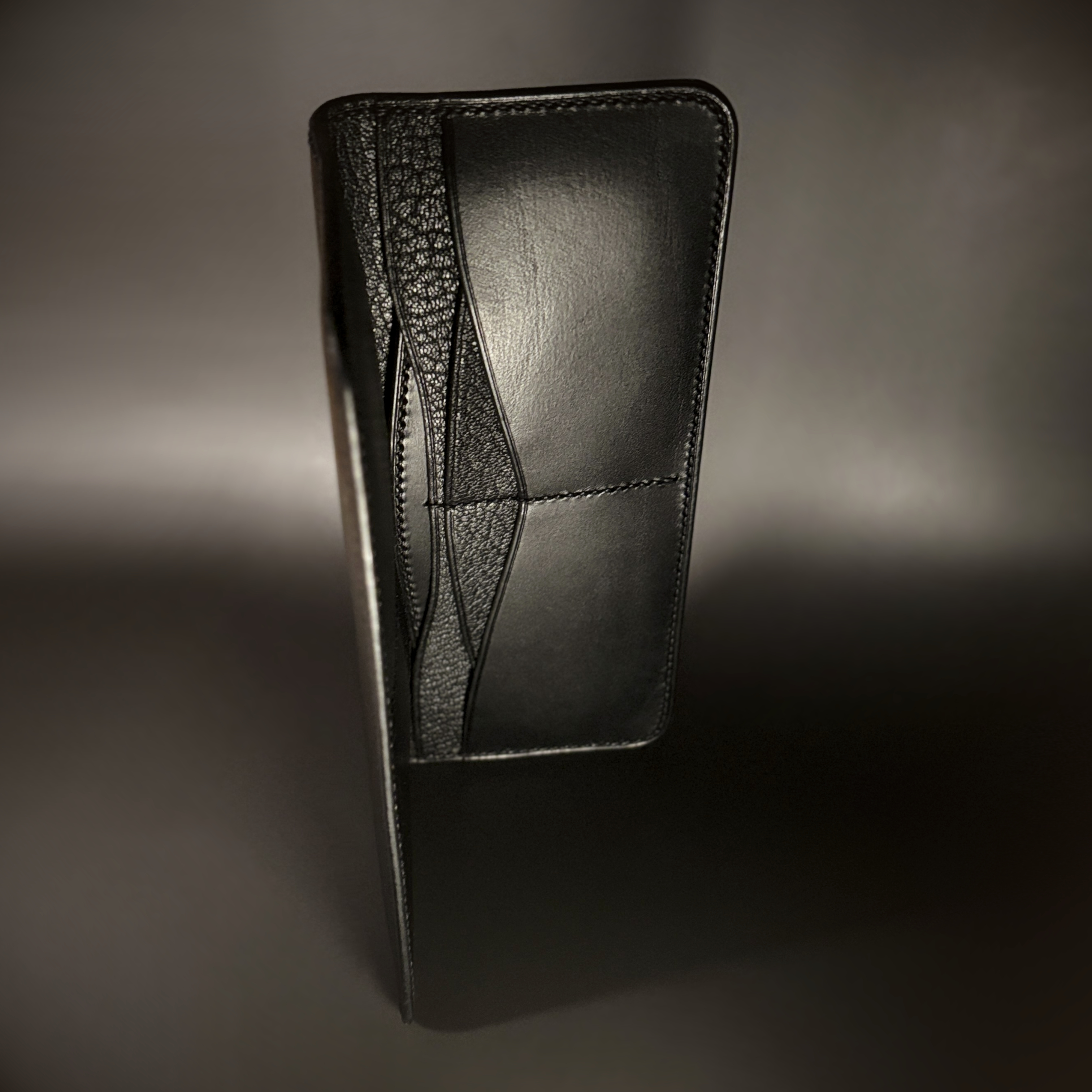 Unique hand-stitched all black cash and card long wallet side view