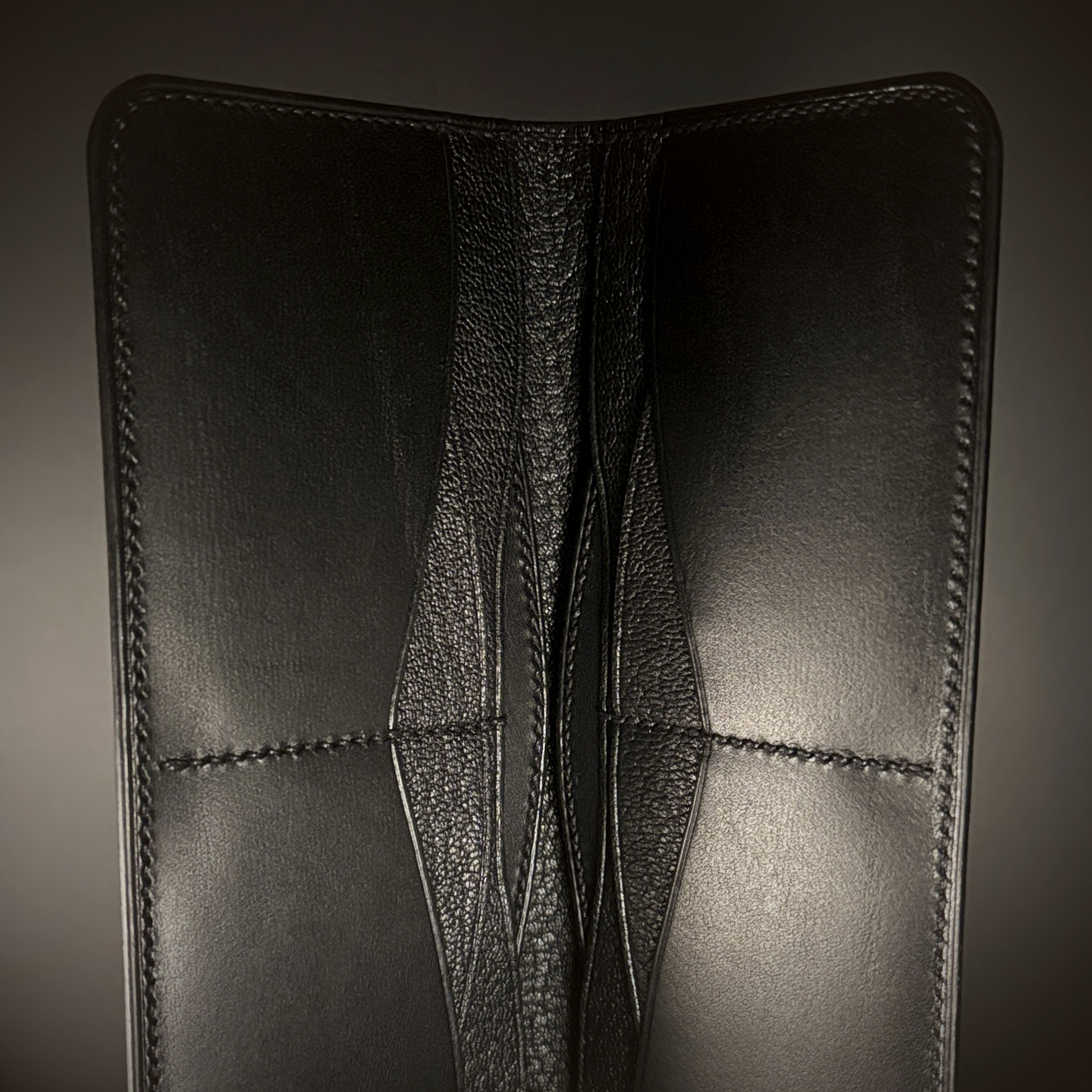 Unique hand-stitched all black cash and card long wallet detailed interior view