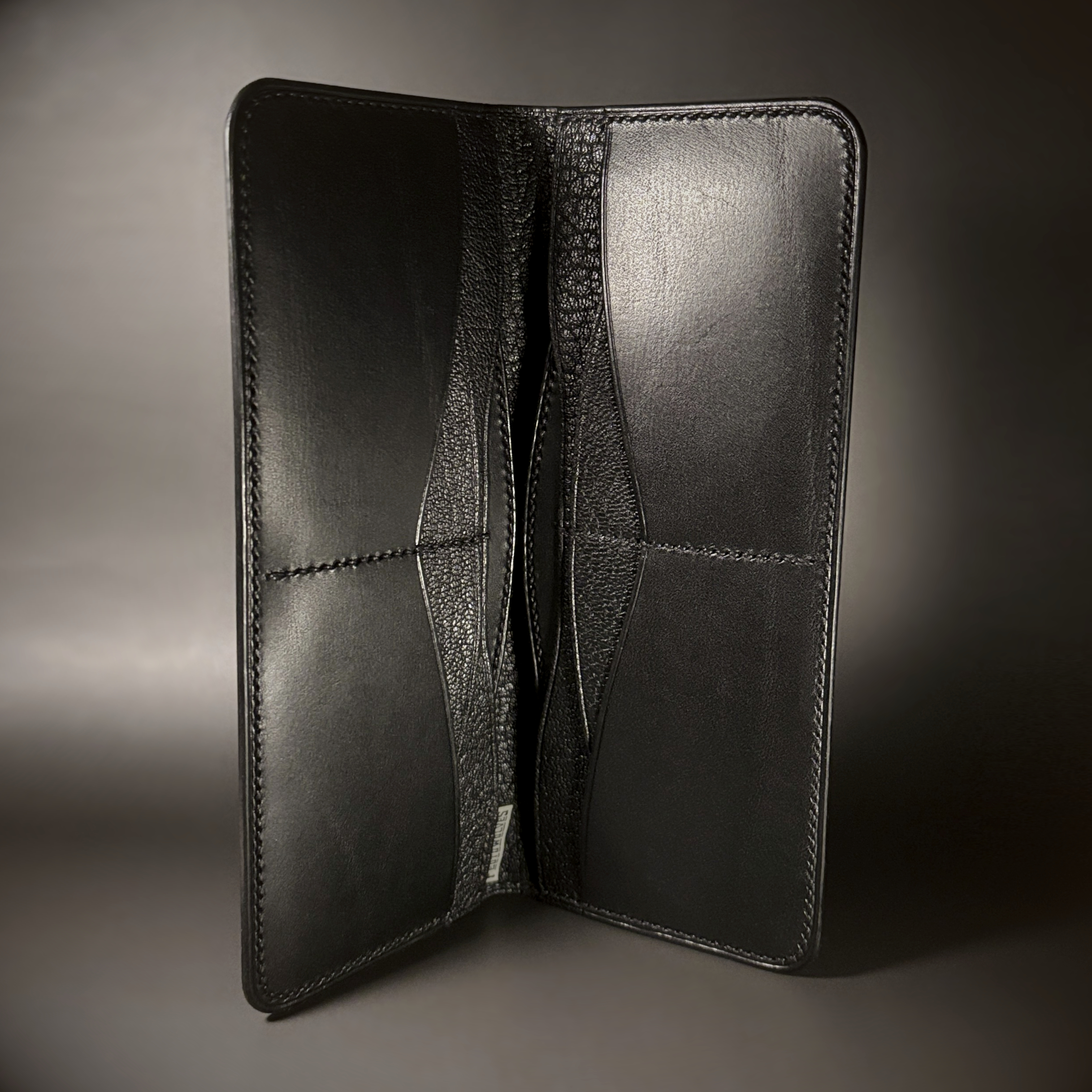 Unique hand-stitched all black cash and card long wallet interior view