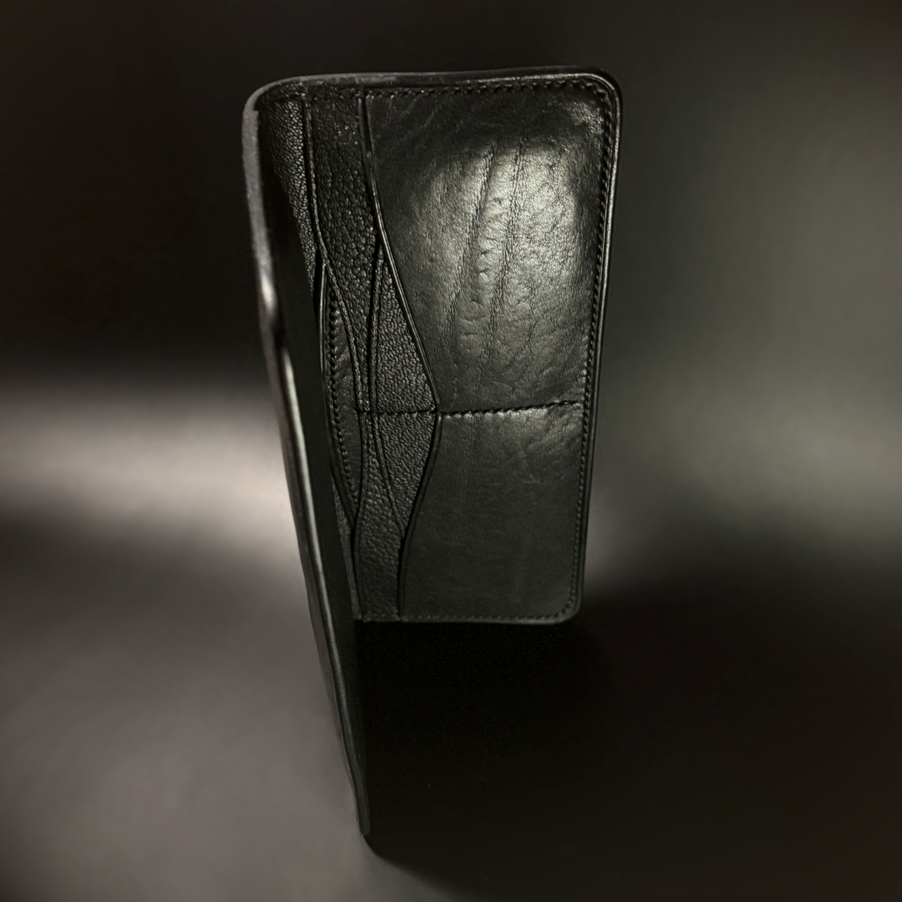 Unique hand-stitched all black cash and card long wallet side view