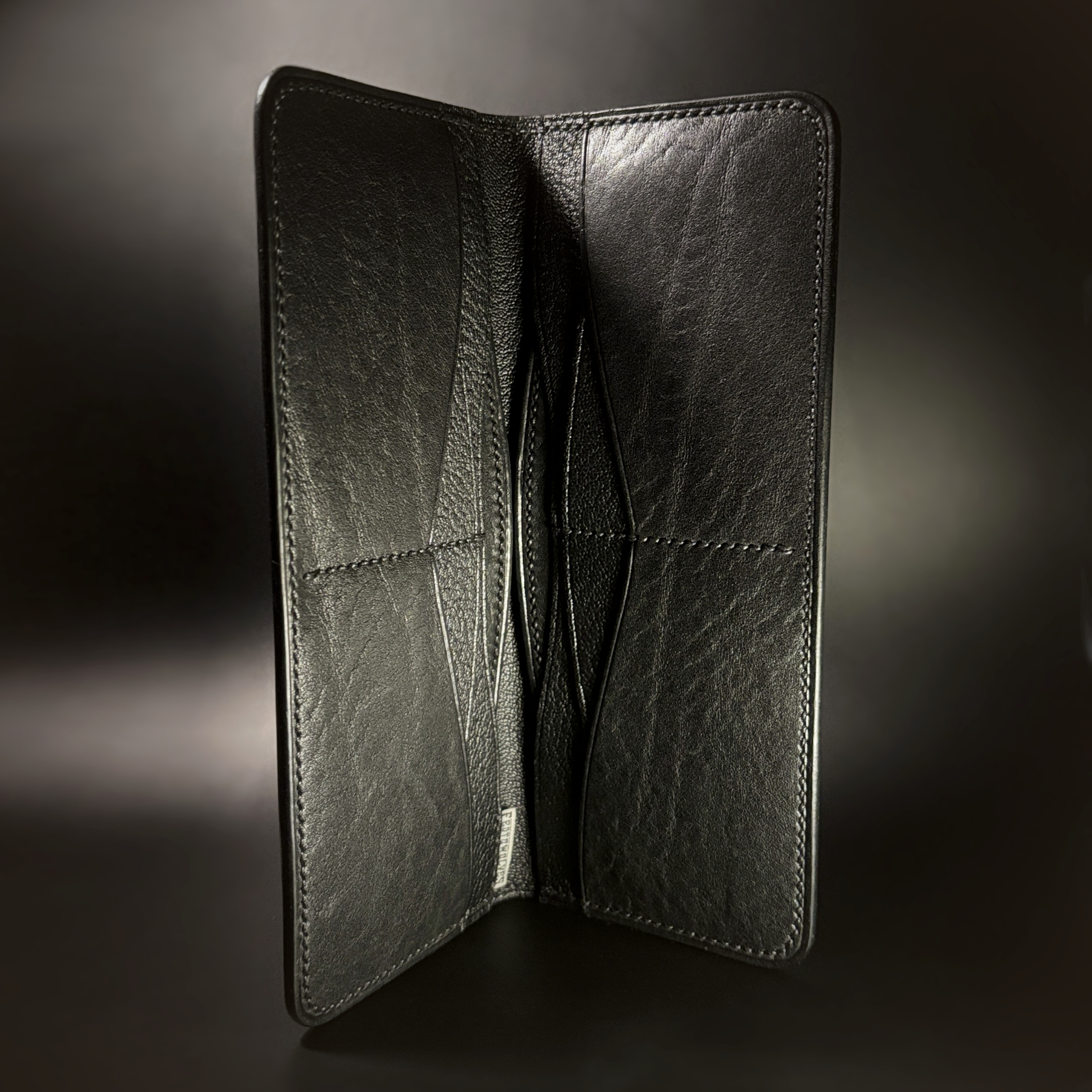 Unique hand-stitched all black cash and card long wallet interior view