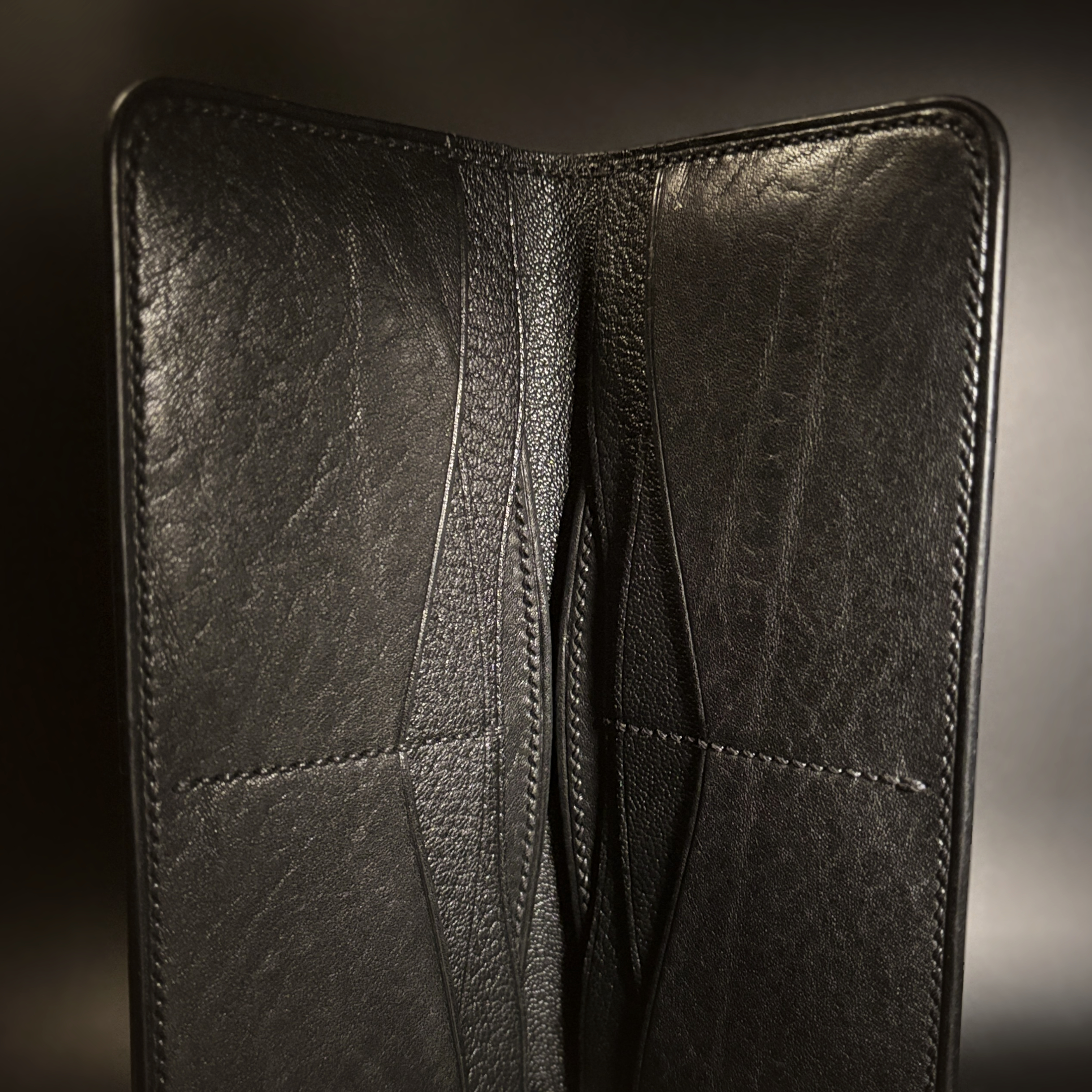 Unique hand-stitched all black cash and card long wallet interior detailed view