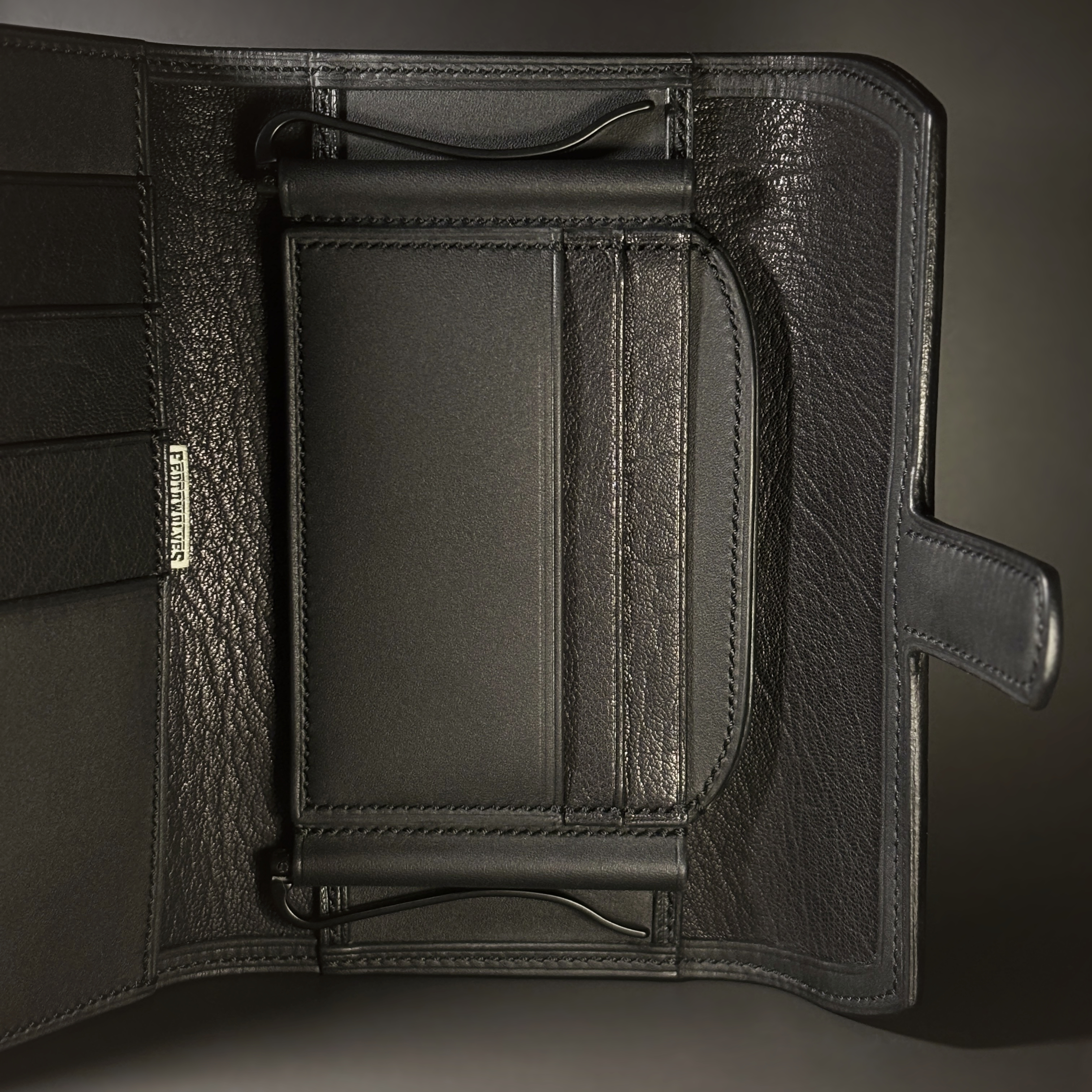 Unique all black hand-stitched tuck strap closure card and cash wallet with money clips detailed interior view