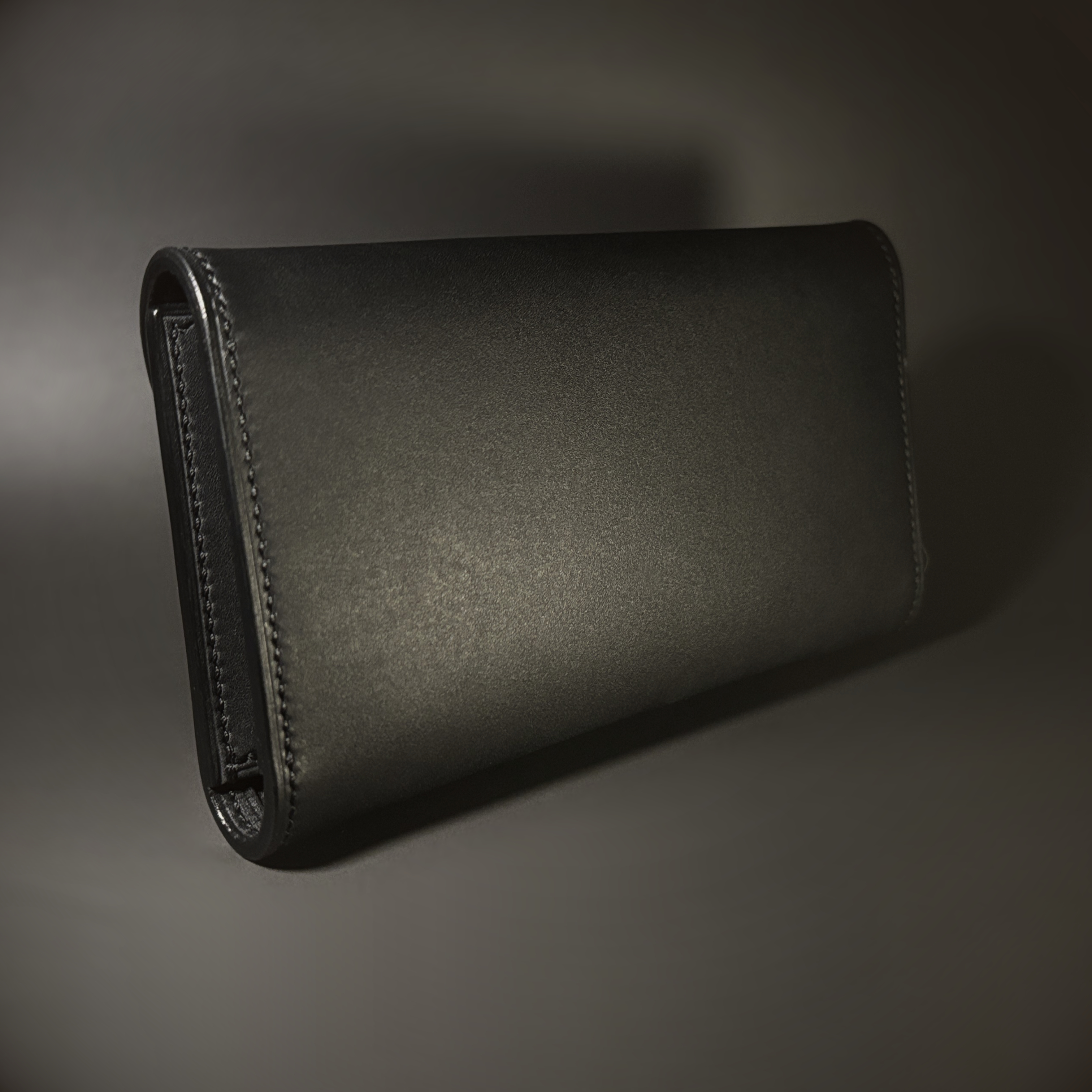 Unique all black hand-stitched tuck strap closure card and cash wallet with money clips exterior shell view