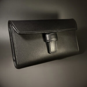 Unique all black hand-stitched tuck strap closure card and cash wallet with money clips exterior shell and tuck closure view