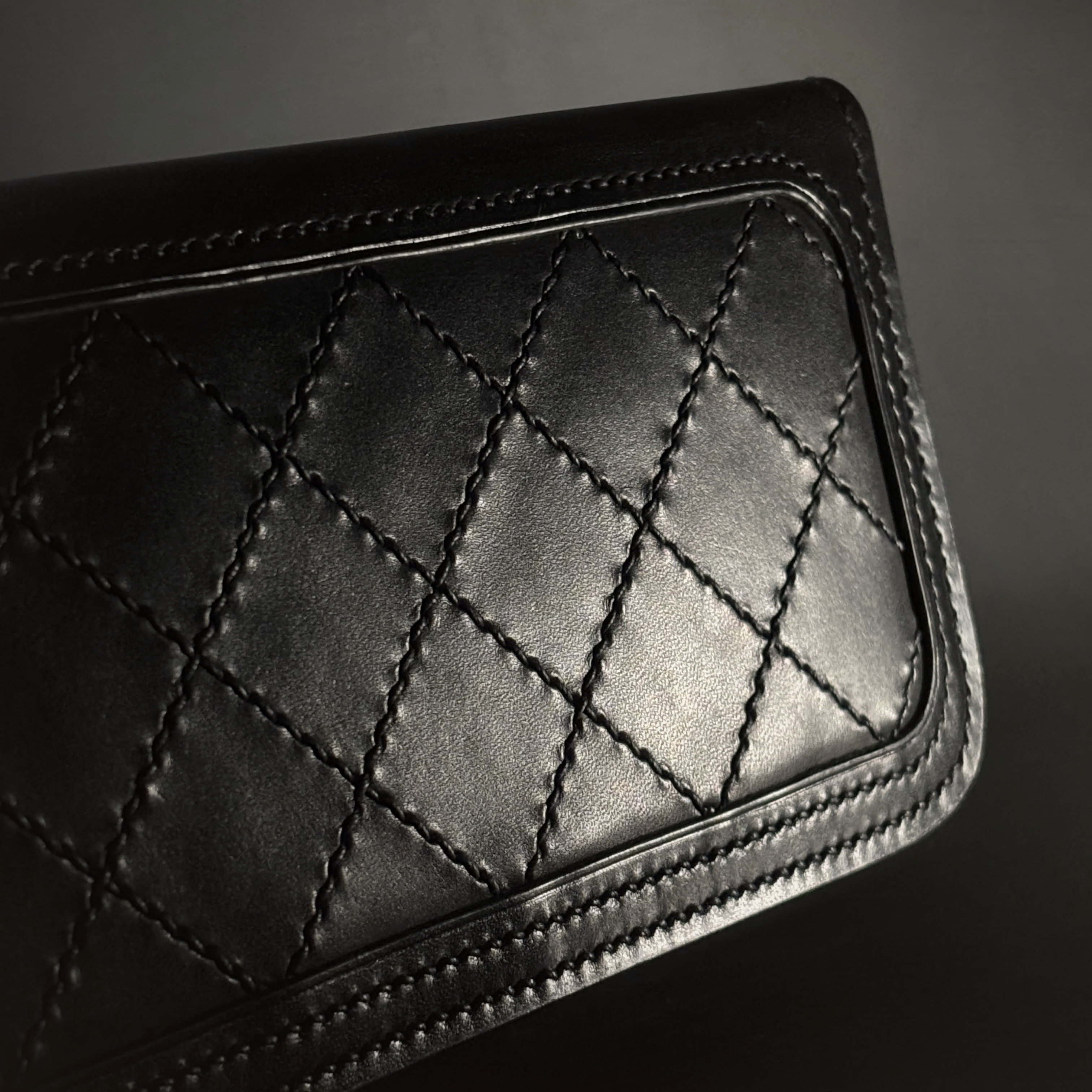 Unique handstitched stingray and quilted shell and black curved interior long wallet side quilted exterior detail view