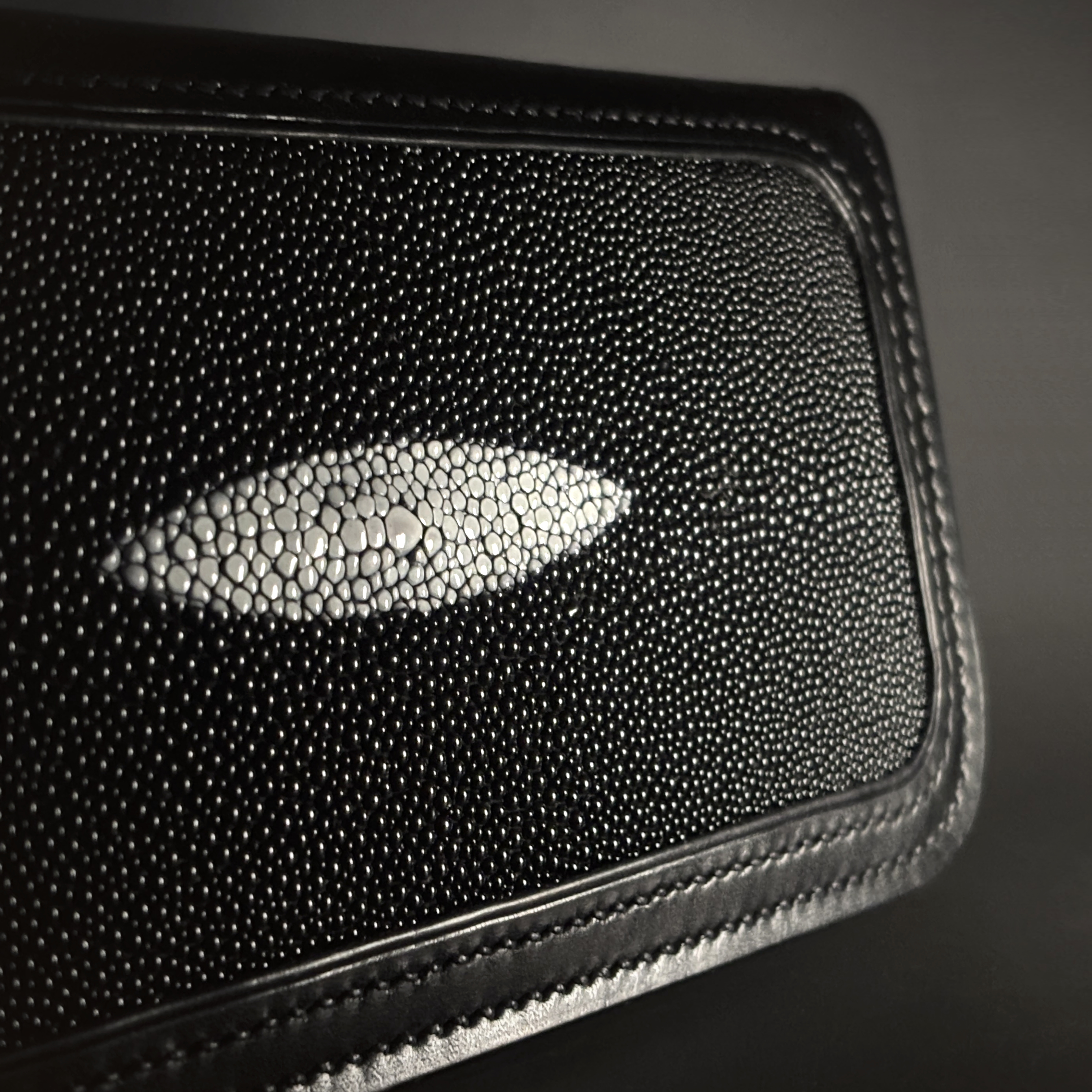 Unique handstitched stingray and quilted shell and black curved interior long wallet side stingray exterior detail view