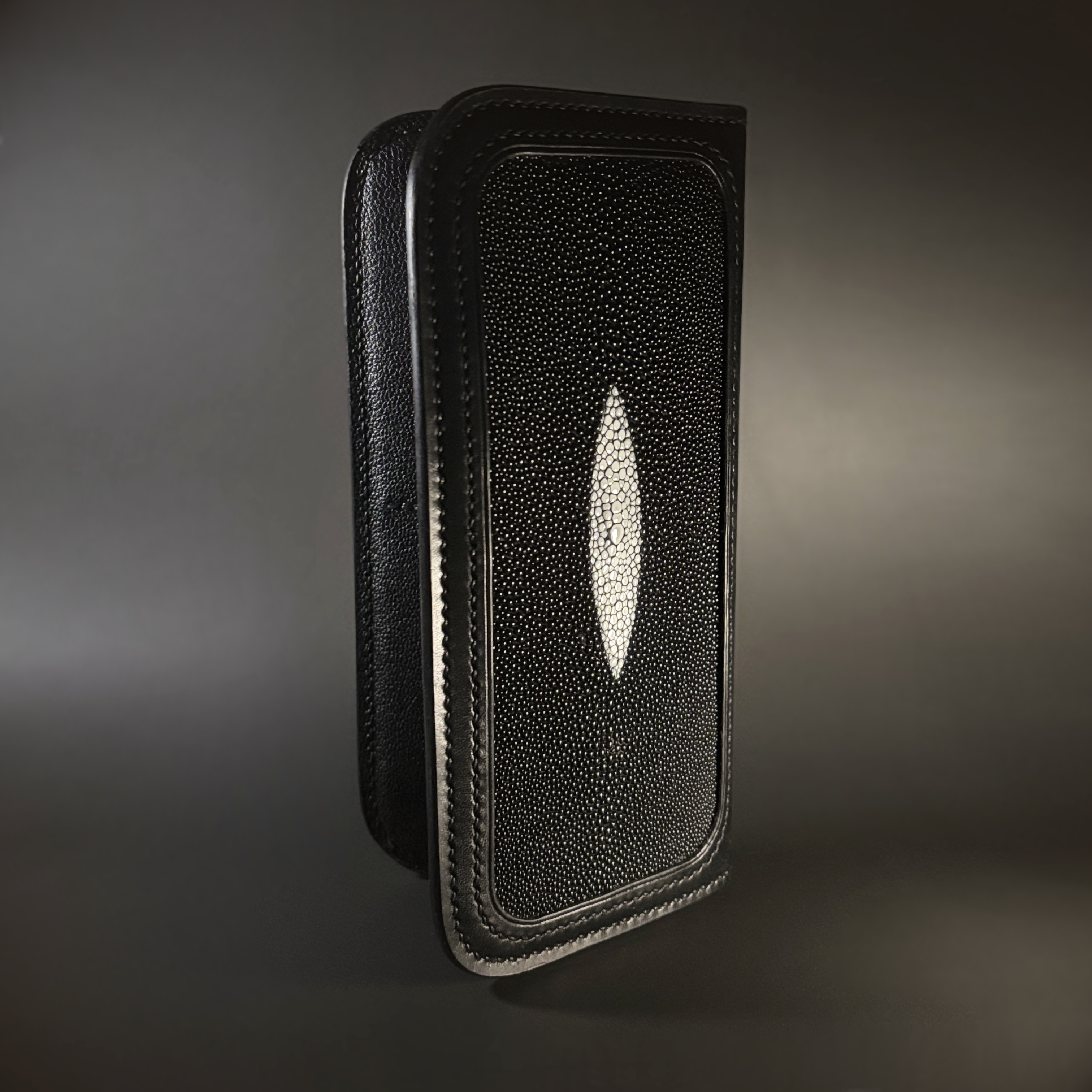 Unique handstitched stingray and quilted shell and black curved interior long wallet side stingray exterior view