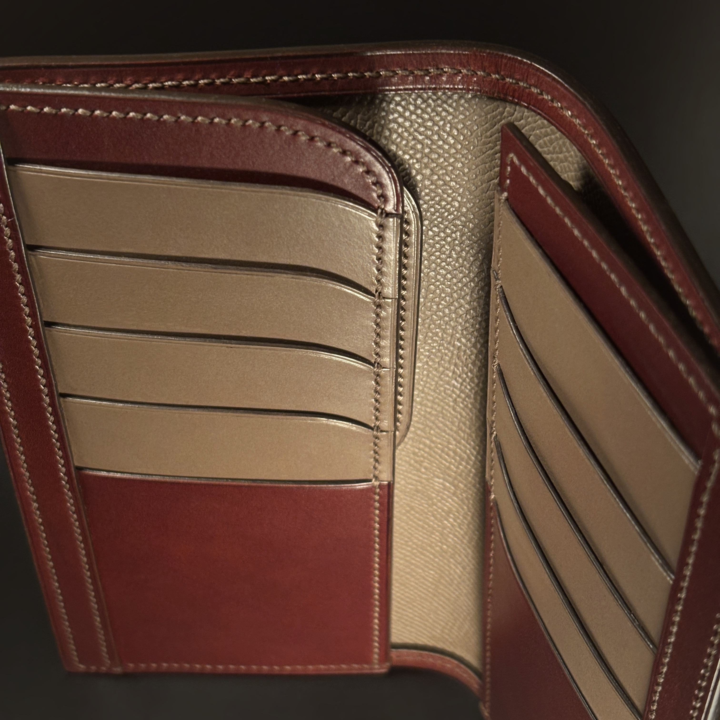 Unique hand-stitched oxblood shell and red and taupe interior cash and card long wallet detailed interior view