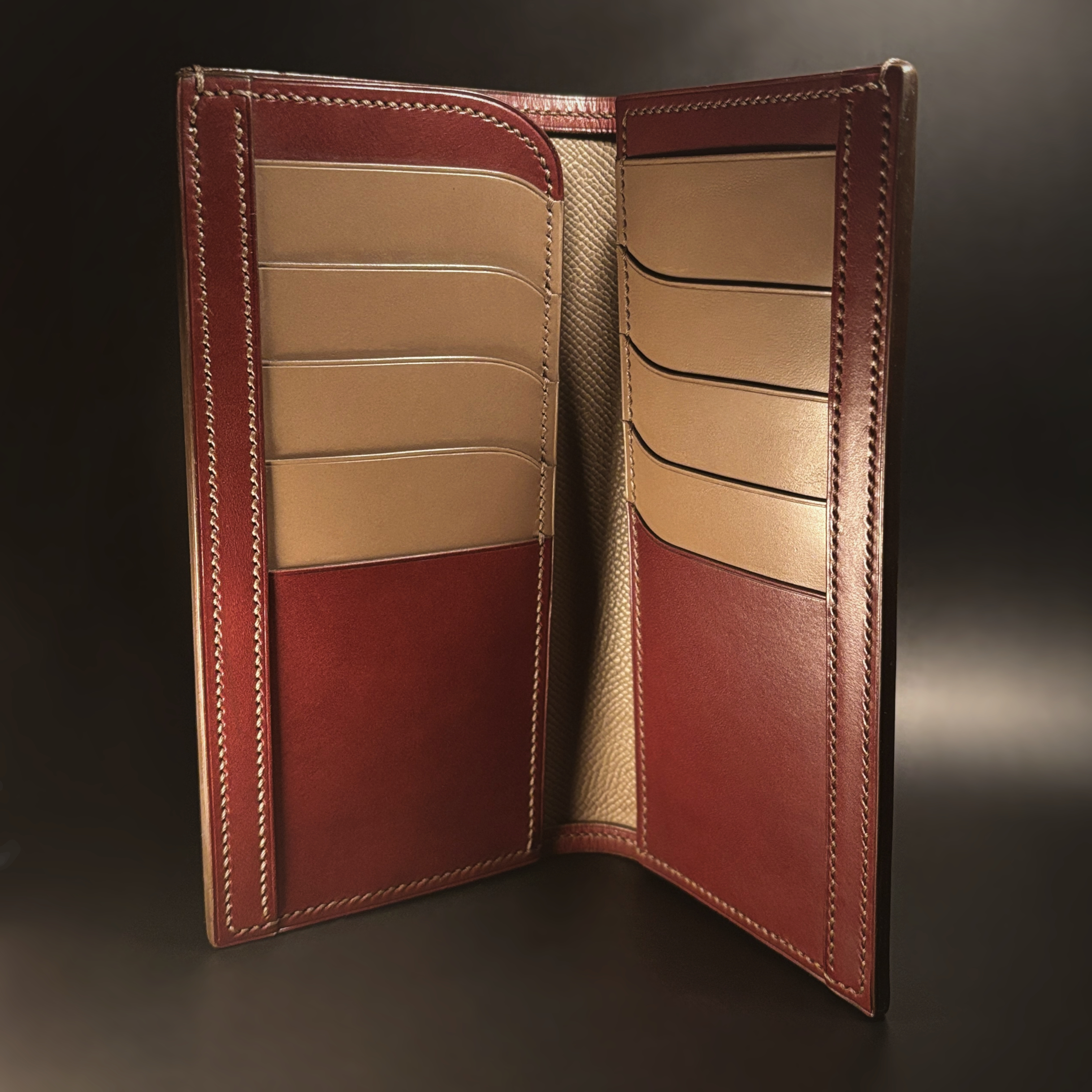 Unique hand-stitched oxblood shell and red and taupe interior cash and card long wallet interior view