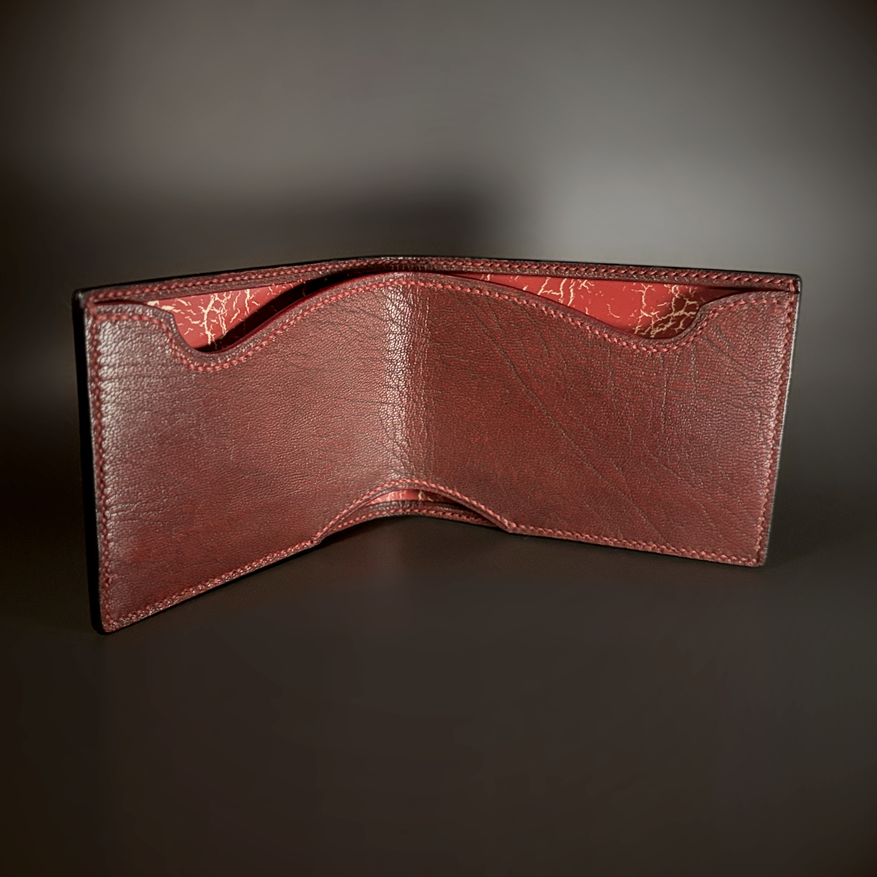 Unique hand-stitched black red and yellow-cracked faceless hidden credit card and cash bifold wallet interior view