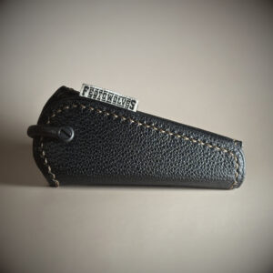 Unique handstitched titanium-hinged black and tan keyfold hinge closed side view