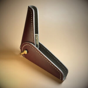 Unique handstitched brass-hinged oxblood red and taupe keyfold open hinge view