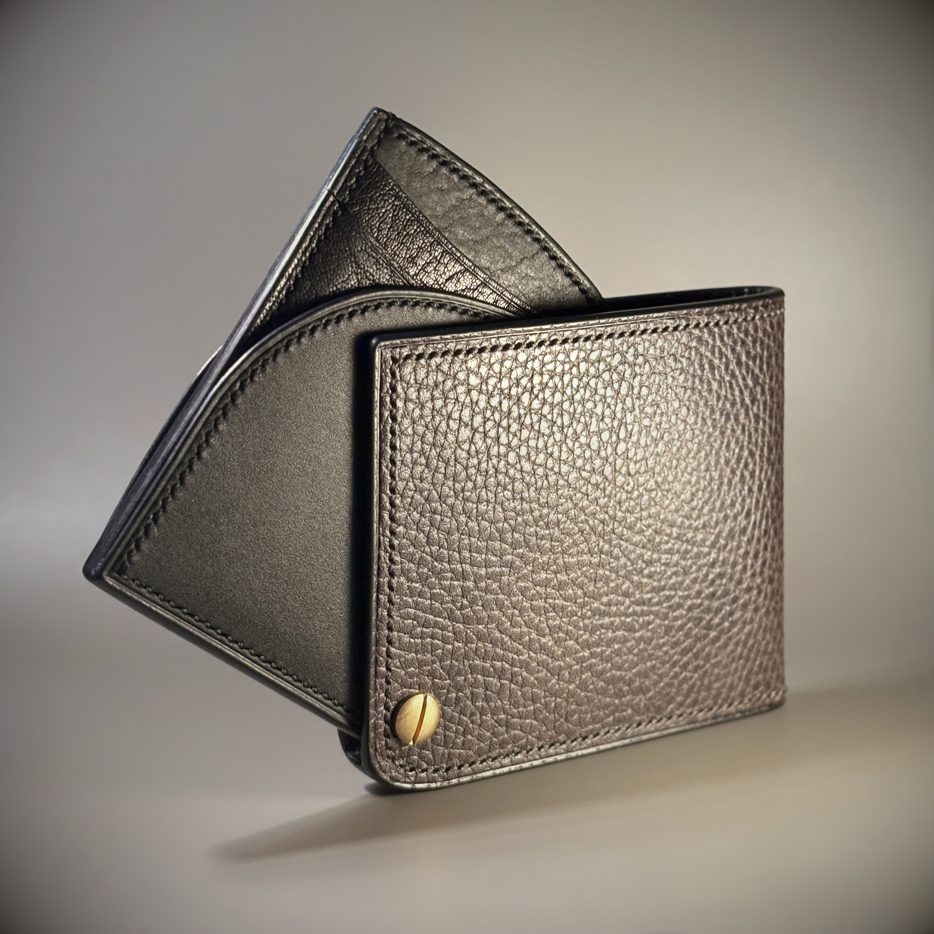 Unique hand-stitched brass hinged brown and black wallet exterior hinge open view