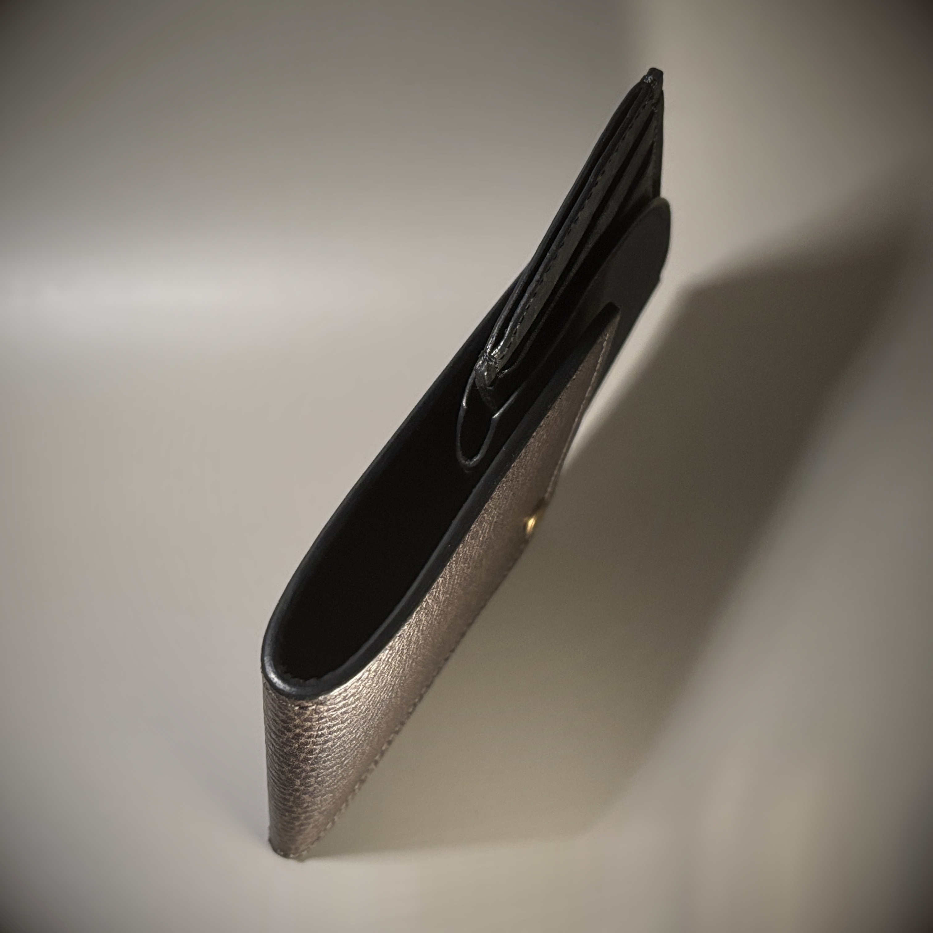 Unique hand-stitched brass hinged brown and black wallet exterior hinge open top view