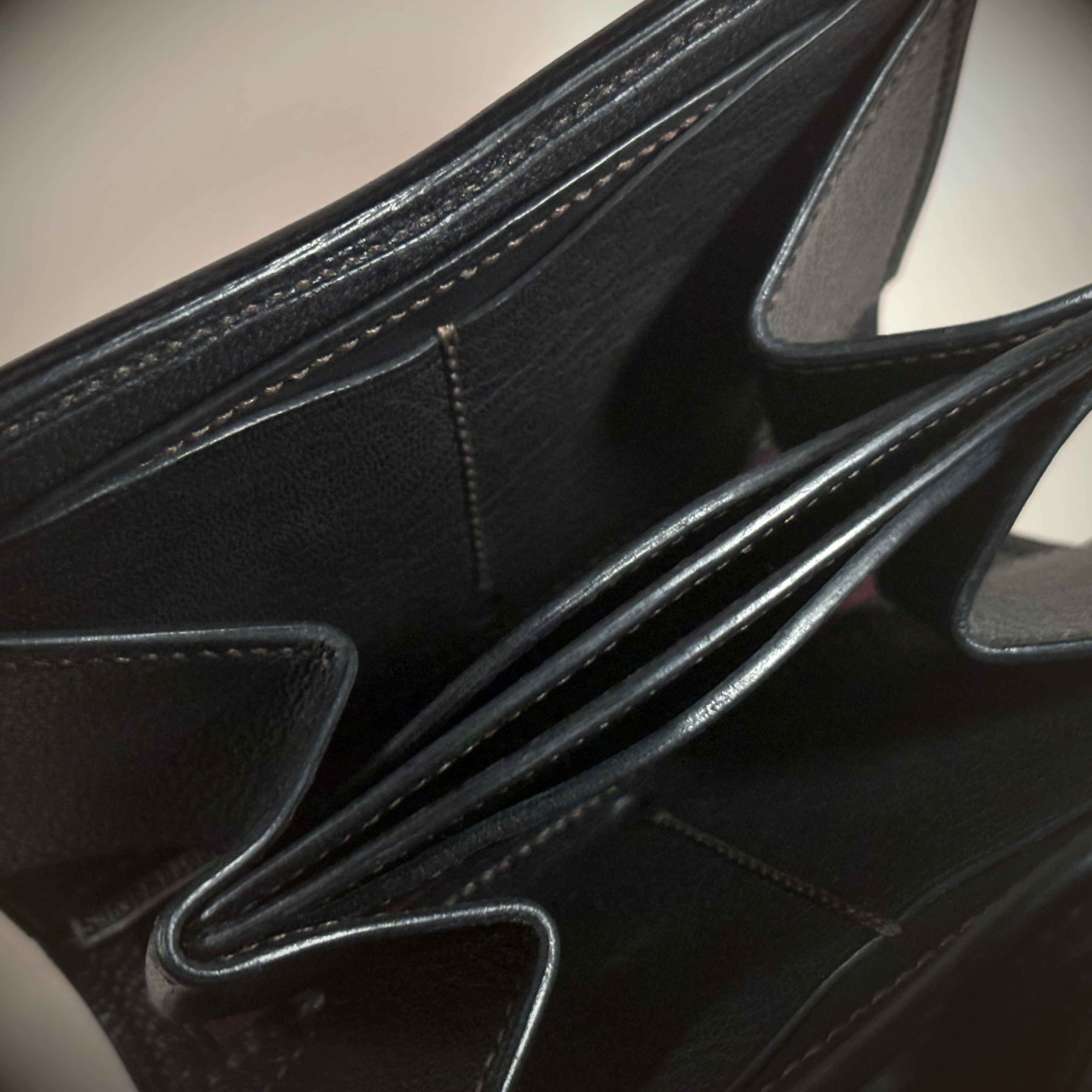 Unique handstitched black with red accent tuck closure purselette accordian interior detail view