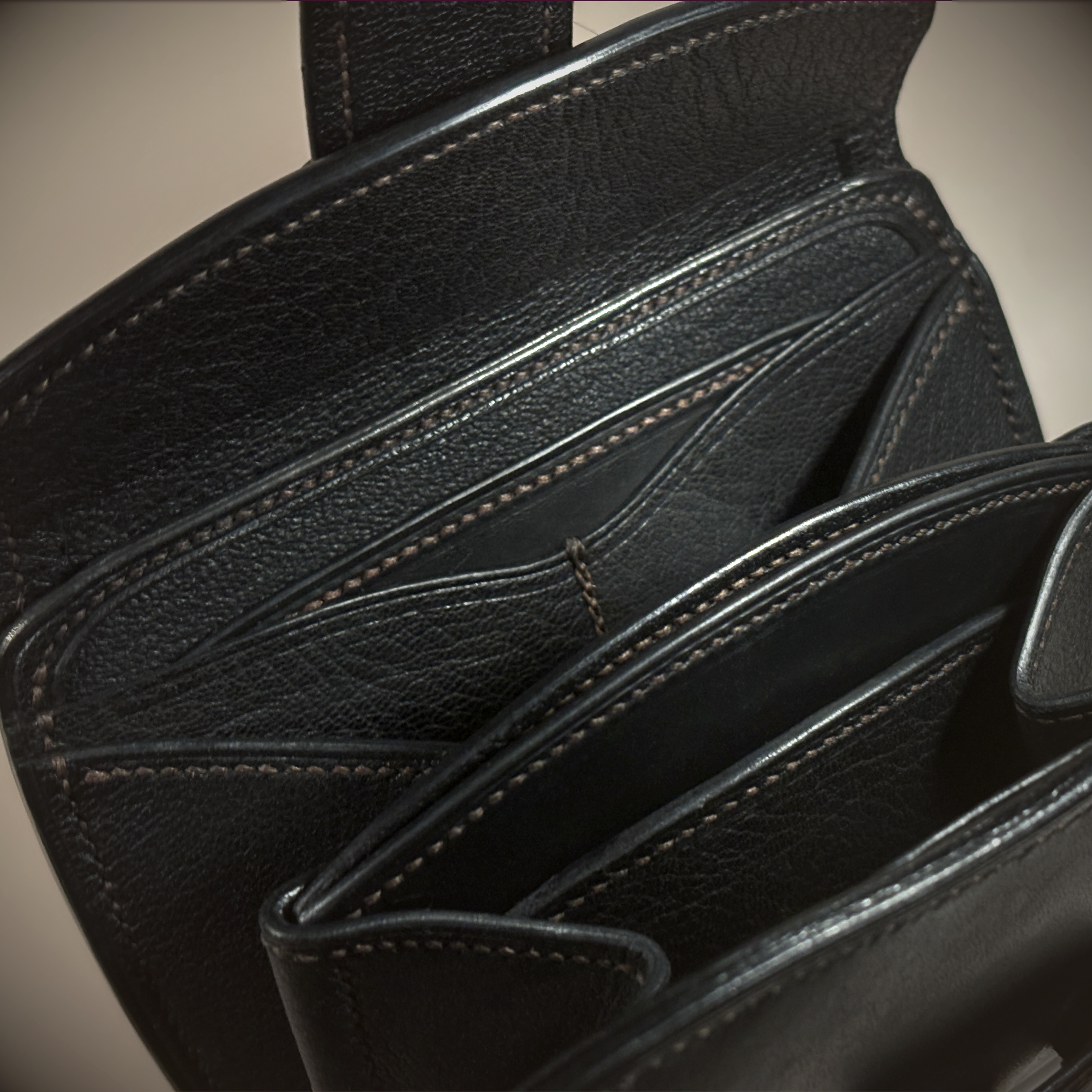 Unique handstitched black with red accent tuck closure purselette accordian interior detail view