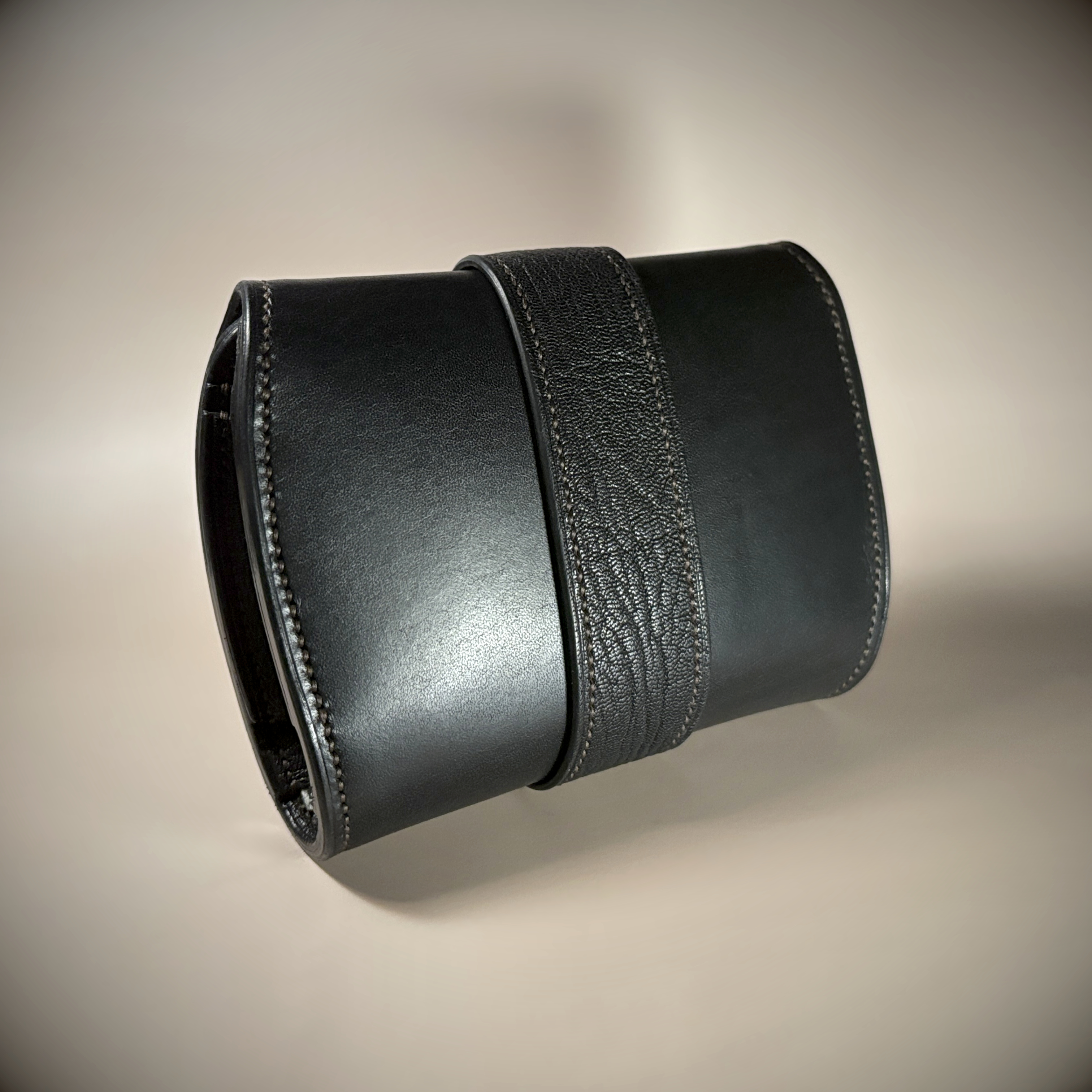 Unique handstitched black with red accent tuck closure purselette exterior shell rear view