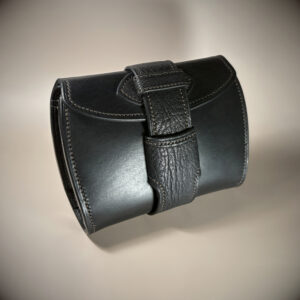 Unique handstitched black with red accent tuck closure purselette exterior shell front view