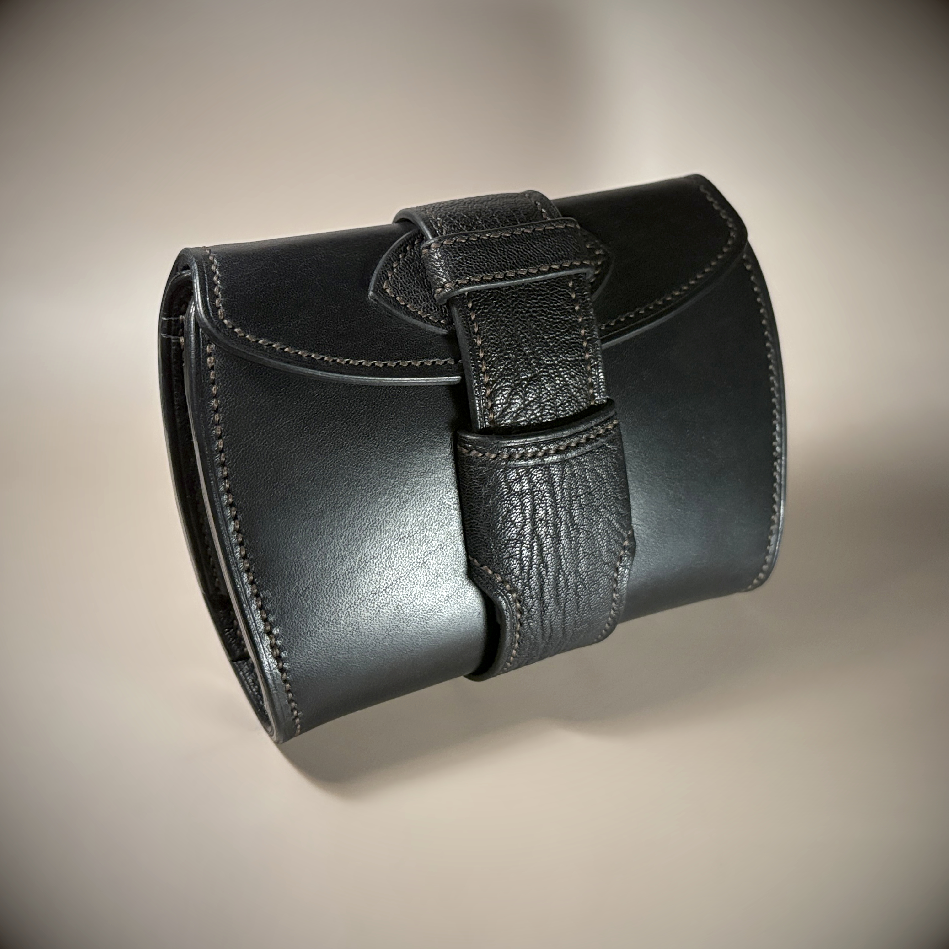 Unique handstitched black with red accent tuck closure purselette exterior shell front view