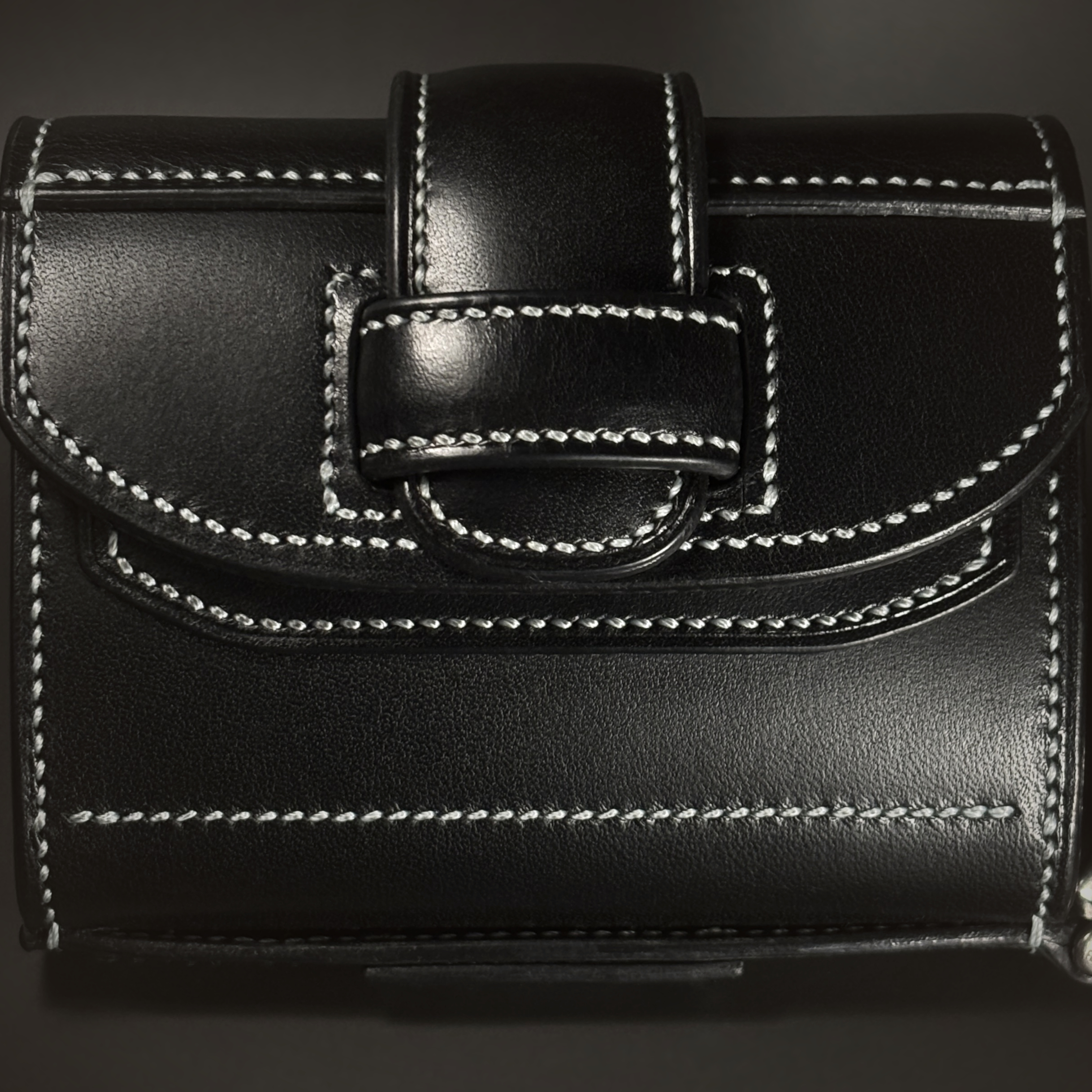 Unique handstitched black tuck closure wristlet strap purselette front closure view