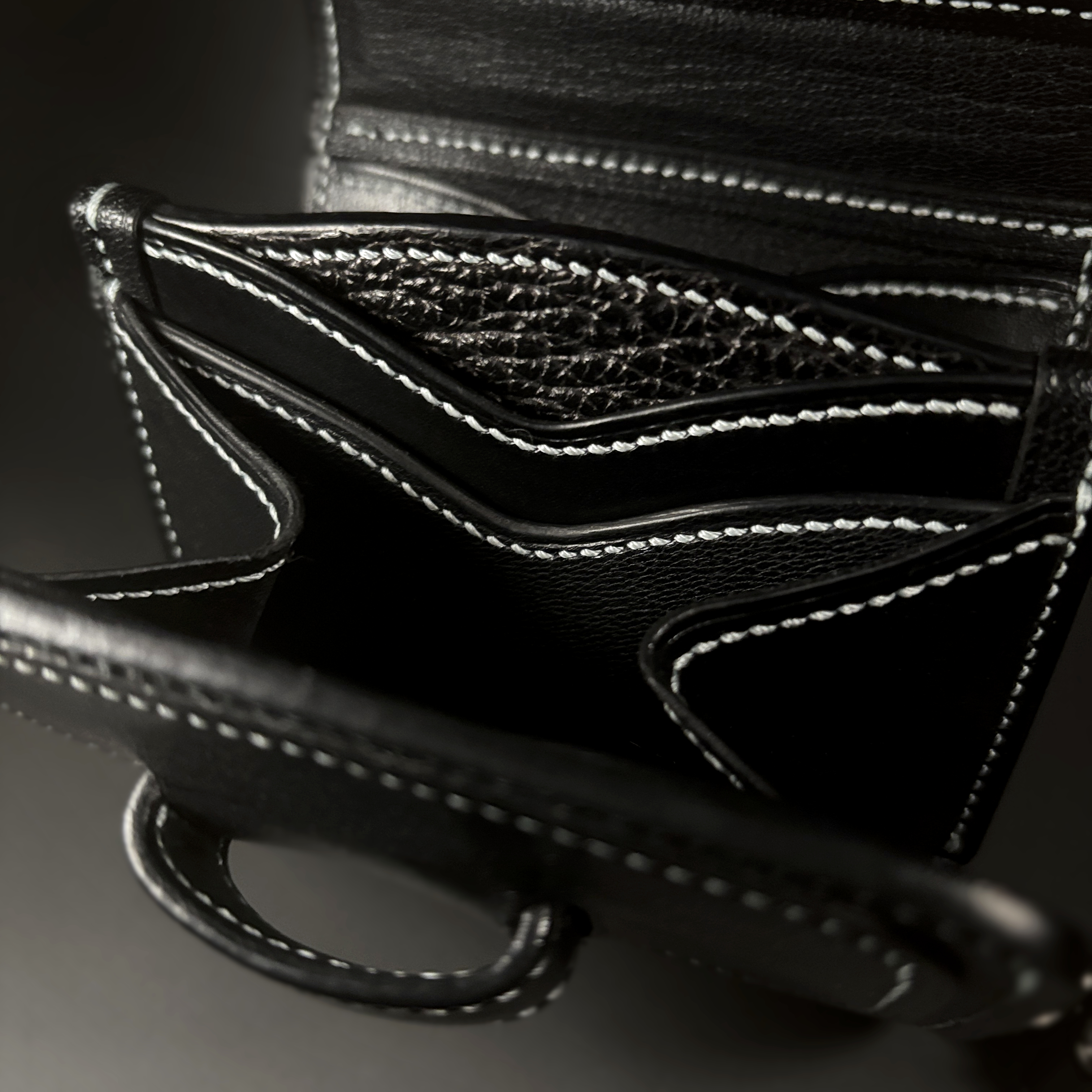 Unique handstitched black tuck closure wristlet strap purselette accordian interior detail view